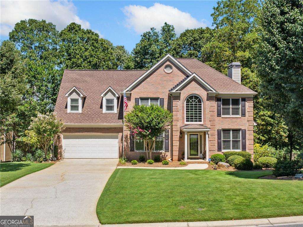 Welcome to a beautifully maintained residence nestled in one of Suwanee's most sought-after neighborhoods, located within South Forsyth County. Stepping inside, you're greeted by a bright, open floor plan grounded by exquisite hardwood flooring and bathed in natural light. The heart of the home - a beautifully appointed kitchen - flows seamlessly into spacious living and dining areas, perfect for both everyday life and entertaining. The living room features custom built-in shelving and a cozy fireplace, creating a warm and inviting focal point for gatherings or quiet evenings in. The kitchen boasts solid surface countertops, a vent hood, wine cooler, and a full suite of stainless steel appliances. The oven and microwave each feature both standard and convection cooking modes, offering elevated functionality for any home chef. The main level features a sophisticated office or sitting room, highlighted by refined moldings-a thoughtful space for productivity or quiet relaxation. A large laundry room is conveniently located on the main floor, with the washer and dryer staying for added convenience. Upstairs, the generously sized primary suite offers a serene retreat with a spa-style ensuite bath featuring granite countertops, tile flooring, a frameless glass shower, and a soaking tub, along with a spacious walk-in closet. Three additional bedrooms complete the upper level. Downstairs, the finished terrace level provides flexible living space ideal for recreation, guests, or a home gym. The recreation room includes a pool table that stays, offering immediate fun and entertainment. Step outside to your private backyard oasis-a flat, fully fenced yard with beautifully designed landscaping, natural creek beds, and a stone path that invites peaceful strolls. Enjoy year-round outdoor living with a covered patio featuring a Dry Below drainage and ceiling system, keeping the space below the deck dry and functional no matter the weather. The 2-car garage provides ample room for storage, vehicles, and hobbies. Enjoy a vibrant lifestyle with nearby parks, trails, and year-round events. Just minutes away are Town Center Park, George Pierce Park, and the scenic Suwanee Creek Greenway-offering everything from outdoor concerts and playgrounds to miles of trails and green space. All this, plus top-rated schools, local dining, and a strong sense of community. This charming home balances refined interior details with modern conveniences, set against a backdrop of Suwanee's vibrant lifestyle and natural beauty. Come experience comfort, community, and connection all in one place-welcome home!