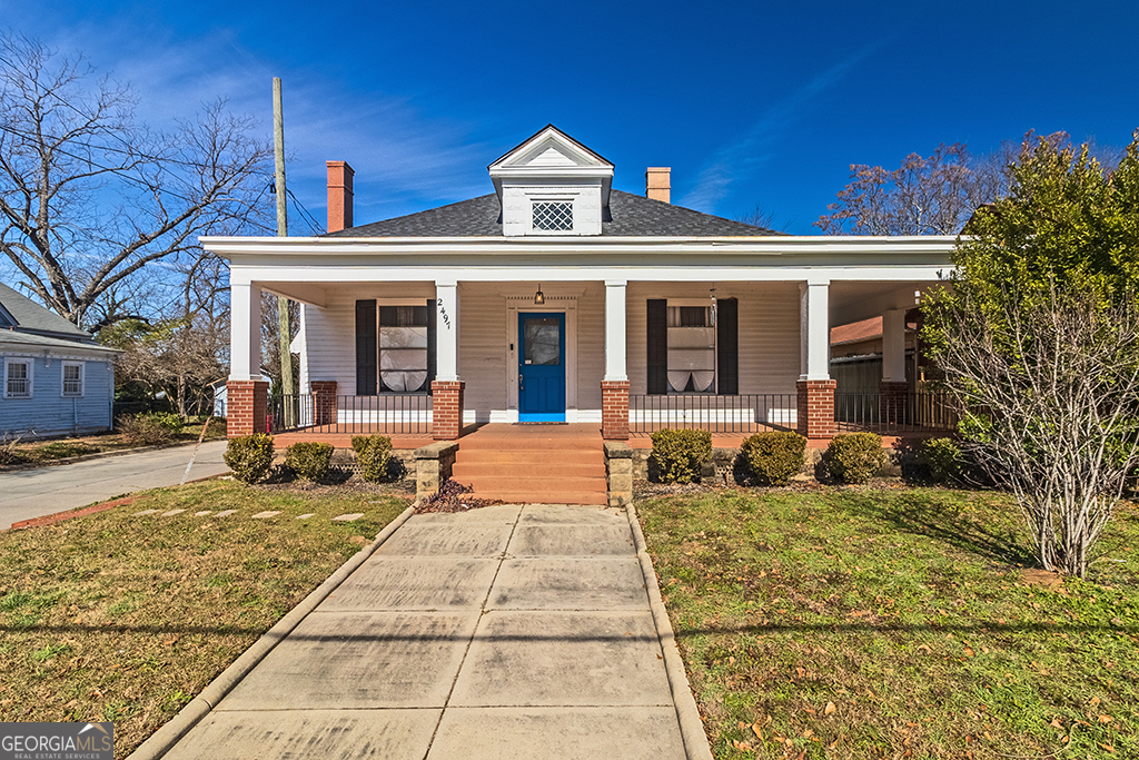 Welcome to Historic Cherokee Heights! Prepare to fall in love with this totally renovated bungalow that perfectly blends timeless charm with modern upgrades. Located less than 2 miles from Mercer University and Mercer University Law School, this rare gem offers an unbeatable combination of location, style, and functionality. As you approach, you'll be captivated by the huge wraparound porch, a serene spot to enjoy your morning coffee or unwind after a long day. Step inside to discover 15-foot ceilings that create an open and airy atmosphere, complemented by the warmth of original hardwood flooring throughout. This 4-bedroom, 2-bath beauty boasts a thoughtfully designed layout, including a spacious living room, a dining area with charming built-in cabinets, and a butler's pantry that adds both character and convenience. A versatile multi-purpose room offers endless possibilities, while the mudroom with washer/dryer connections ensures practicality for everyday living. The fenced backyard is perfect for gatherings, barbecues, or simply enjoying some outdoor tranquility. Whether you're a buyer seeking the vibrant lifestyle of West Downtown or an investor eyeing a fantastic rental opportunity, this home checks all the boxes. Don't miss your chance to own a piece of history with modern flair. Schedule your tour today and experience the charm of Cherokee Heights for yourself!