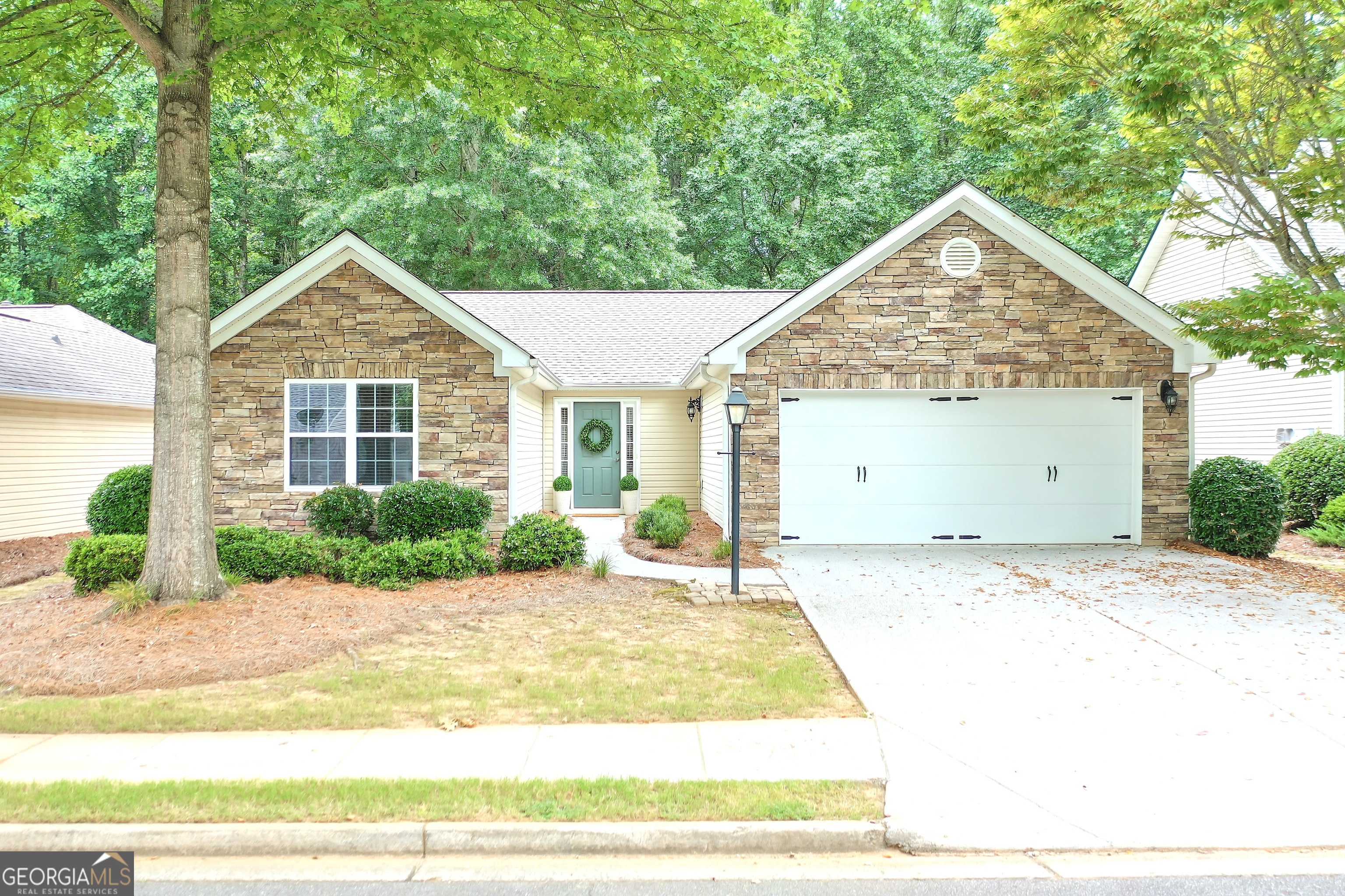 Welcome to your charming one-level, stepless, ranch retreat in the heart of Cobb County! Tucked into a friendly swim/tennis community, this adorable home offers the perfect blend of peaceful privacy and unbeatable location. BACKING UP TO THE NEIGHBORHOOD GREENSPACE, you'll enjoy serene views and added privacy while still being just minutes from Historic Downtown Acworth, vibrant Kennesaw, Lake Allatoona, and all the shopping and dining of Woodstock. Inside, soaring vaulted ceilings and gleaming hardwood floors welcome you into the spacious great room with a gas log fireplace, perfect for cozy nights or entertaining friends. The sun-drenched VAULTED SUNROOM opens to a private ENLARGED PATIO, ideal for morning coffee or evening relaxation. The kitchen is a chef's delight, featuring granite countertops, tile backsplash, and stainless steel appliances including a NEWER REFRIGERATOR AND MICROWAVE. The master suite has a full bathroom with a double vanity, shower, and very large walk-in closet. Don't miss the oversized vaulted secondary bedroom, which offers incredible flexibility: use it as a home office, gym, or rec room-the choice is yours! All on one easy-living level with no stairs to worry about, this home is as functional as it is stylish. And don't forget-this home is located in Cobb County, which offers one of the best SENIOR TAX EXEMPTIONS in Georgia, making it an even smarter investment for long-term living. Also so very important for easy living the HVAC is BRAND NEW, the HOT WATER HTR IS ONLY 3 YRS, and the ROOF is +/- 7 YRS! Come see this gem today and experience the perfect combination of comfort, community, and convenience!