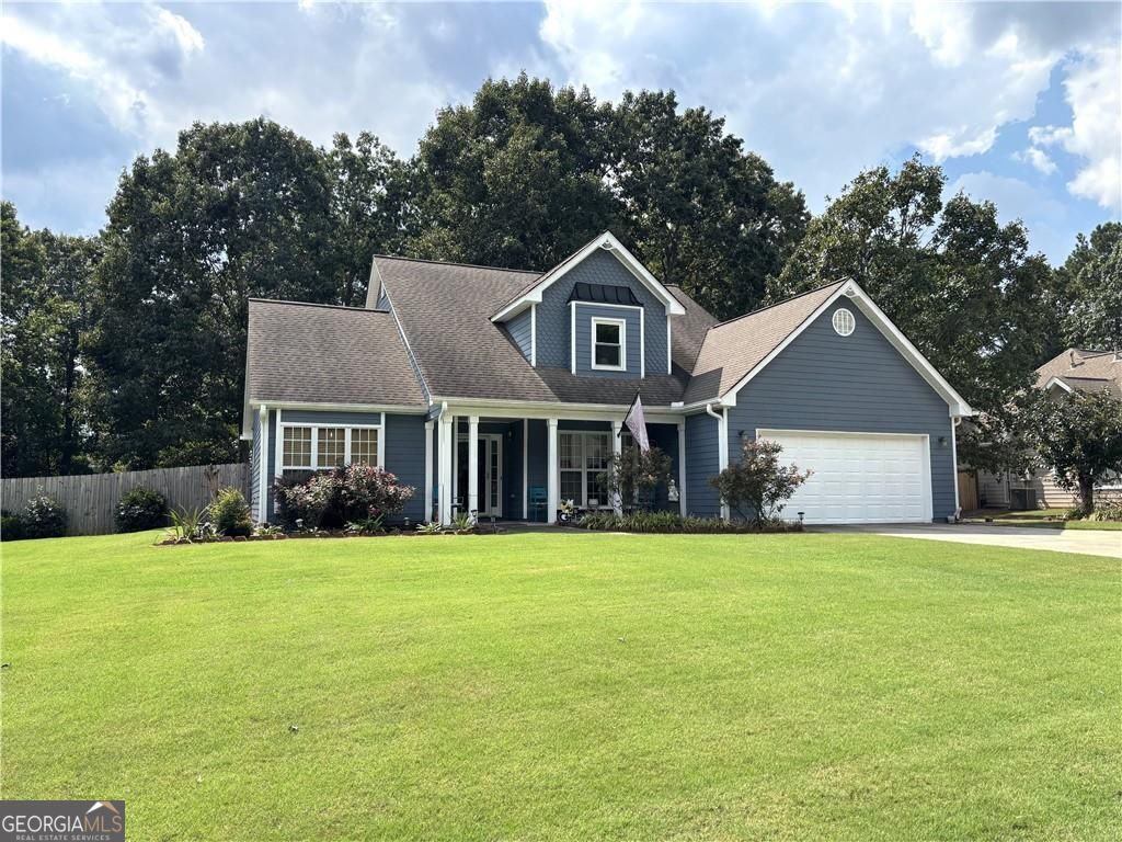 Discover your new Home with a peaceful setting on over a 1/2 Acre fenced lot with an inviting covered front porch! Plenty of possibilities exist in this all electric property that has many updates including many new windows, new flooring upstairs and in the sunroom. Two story foyer and Family room exuding abundant natural light, a double sided fireplace and gorgeous flooring connects to the Eat in Granite Kitchen with more than enough cabinet space. Kitchen has SS appliances and quick access to sunroom and to your own separate Dining room to gather together with family and friends. Your great sized Owner's suite on the main has vaulted ceiling, soaking tub, separate shower, and dual vanity. A half bath for guests and laundry room complete the main level. Upstairs are your 2 spacious secondary bedrooms and hall bath. Whole attic storage provides options for expanding. You'll enjoy one of the best back yards ever with landscaping, nature, and sunsets to enjoy for years to come!