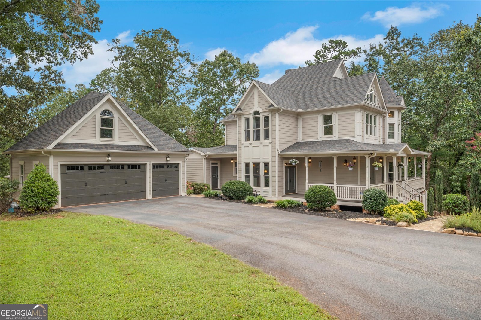 Nestled on 5.68 acres in Dawsonville, this stunning custom estate is a private sanctuary where exquisite craftsmanship and refined luxury greet you at every turn. Every detail-from the incredible outdoor swimming pool and spa to the soaring 10-foot ceilings and 8-foot solid mahogany doors to 10-inch baseboards, crown and shadow molding, rich red oak hardwood floors, and solid wood cabinetry-speaks to the exceptional quality and thoughtful design woven throughout. The main level unfolds with an inviting wrap-around front porch, a grand foyer, a gourmet chef's kitchen with a cozy fireplace and walk-in pantry, and a banquet-sized dining room that transitions into a luminous family room anchored by yet another fireplace. You'll also discover a spacious home office and a practical mud room that perfectly balance elegance and functionality. Upstairs, a magnificent owner's suite with a fireplace and a luxurious bath awaits alongside generously sized secondary bedrooms with upgraded bathrooms, plus a versatile third-floor bonus space that can flex as a bedroom, media room, or playroom. The fully finished terrace level functions like an in-law suite-complete with a full kitchen, bar, media and games areas, a full bath, and a bedroom-ideal for guests or multigenerational living. Outside, embrace outdoor living on a generous deck that overlooks the property, and enjoy resort-style relaxation with a gorgeous saltwater pool featuring a hot tub, waterfall, and cabana. Additional highlights include a three-car garage with EV charger and potential guest suite or office above, a large electric-equipped pole barn, secure gated entry, a dog run, and many more refined touches. This one-of-a-kind estate offers unmatched privacy, versatility, and craftsmanship-a rare find in Dawsonville. Welcome home!