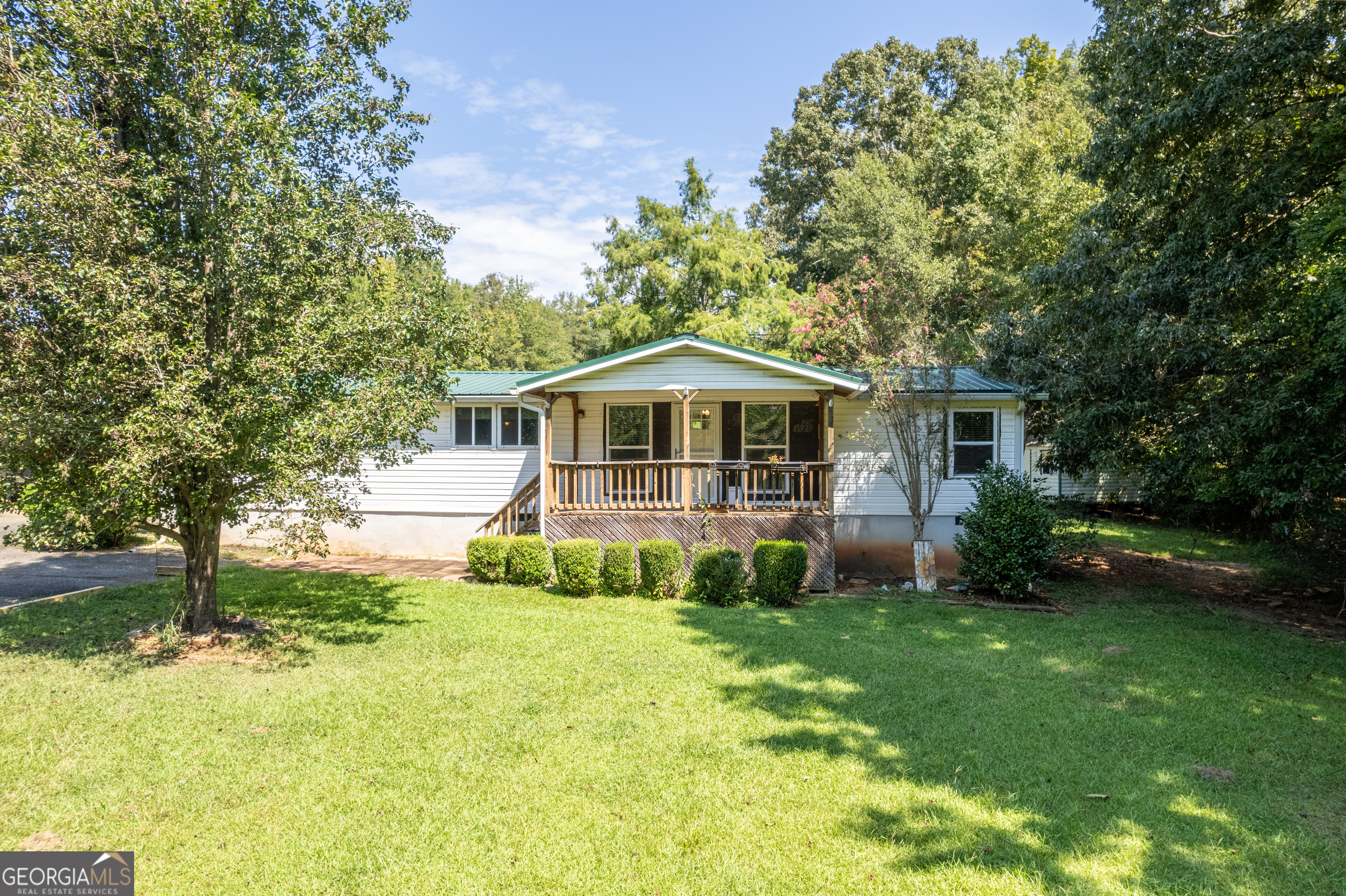 Come check out this newly remodeled 3 bedroom/2 bath home with private community lake access. This home offers sheetrock throughout with new insulation, all new doors and windows, new HVAC with ductwork, updated bathrooms and kitchen, LED lights, new subfloor and flooring, a moisture barrier with a permanent dehumidifier underneath, and a tankless water heater. It has a beautiful kitchen island, all new appliances and is open concept. There is a gorgeous back deck with hot tub and a covered area for the grill. It has a spacious back yard with above ground salt-water pool and seasonal views of the lake. Directly across the street is a private dock and lake access for this community only. Don't miss out on this great opportunity! Sold AS-IS.
