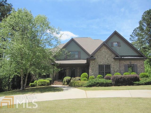 This 5BR/4.5 BA home offers a large family room with coffered ceiling and stone fireplace which opens to a kitchen with large island with breakfast bar plus screen porch, separate dining room, and office/study with built-ins and stained trim, chair rail, and shadow box paneling. Large master suite with trey ceiling, master bath with over sized shower and separate vanities. Finished terrace level has stained concrete floors and includes 5th bedroom, full bath, family room, exercise room/possible 6th bedroom, wet bar, and huge 2nd laundry area/craft room. Hardwood throughout expect for one bedroom upstairs. Located on large private level lot with fire pit, circular driveway, and three car garage. Adjoining lot with approx. 1.2 acres also available.