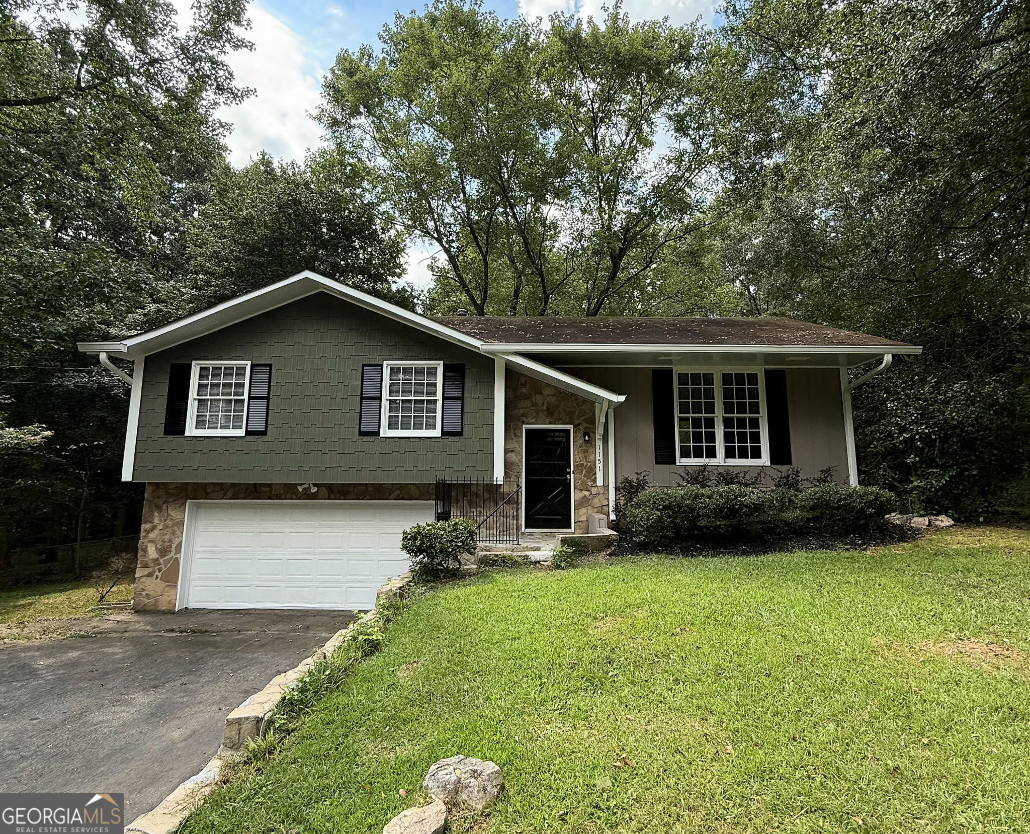 Charming Split-Level Home in Prime Watkinsville Location! Welcome to this beautifully maintained 3-bedroom, 2-bath split-level home located just minutes from shops, restaurants, and all that Watkinsville has to offer. Featuring a cute kitchen with new granite countertops and stainless-steel appliances, this home offers both style and functionality. Enjoy the primary en-suite bath complete with a granite vanity and tiled walk-in shower. This home boasts plenty of storage as well as room to grow with the unfinished space on the lower level. Turn this space into a workshop, craft room, or an office! Walk through the kitchen and dining area with French doors onto the generous back deck. This deck and the large, fenced backyard are ideal for entertaining, pets, or playing. Additional highlights include a new water heater, an attached garage, plenty of storage throughout, new LVP downstairs, and new carpeting in bedrooms. This move-in-ready gem offers comfort, convenience, and charm in a sought-after location.