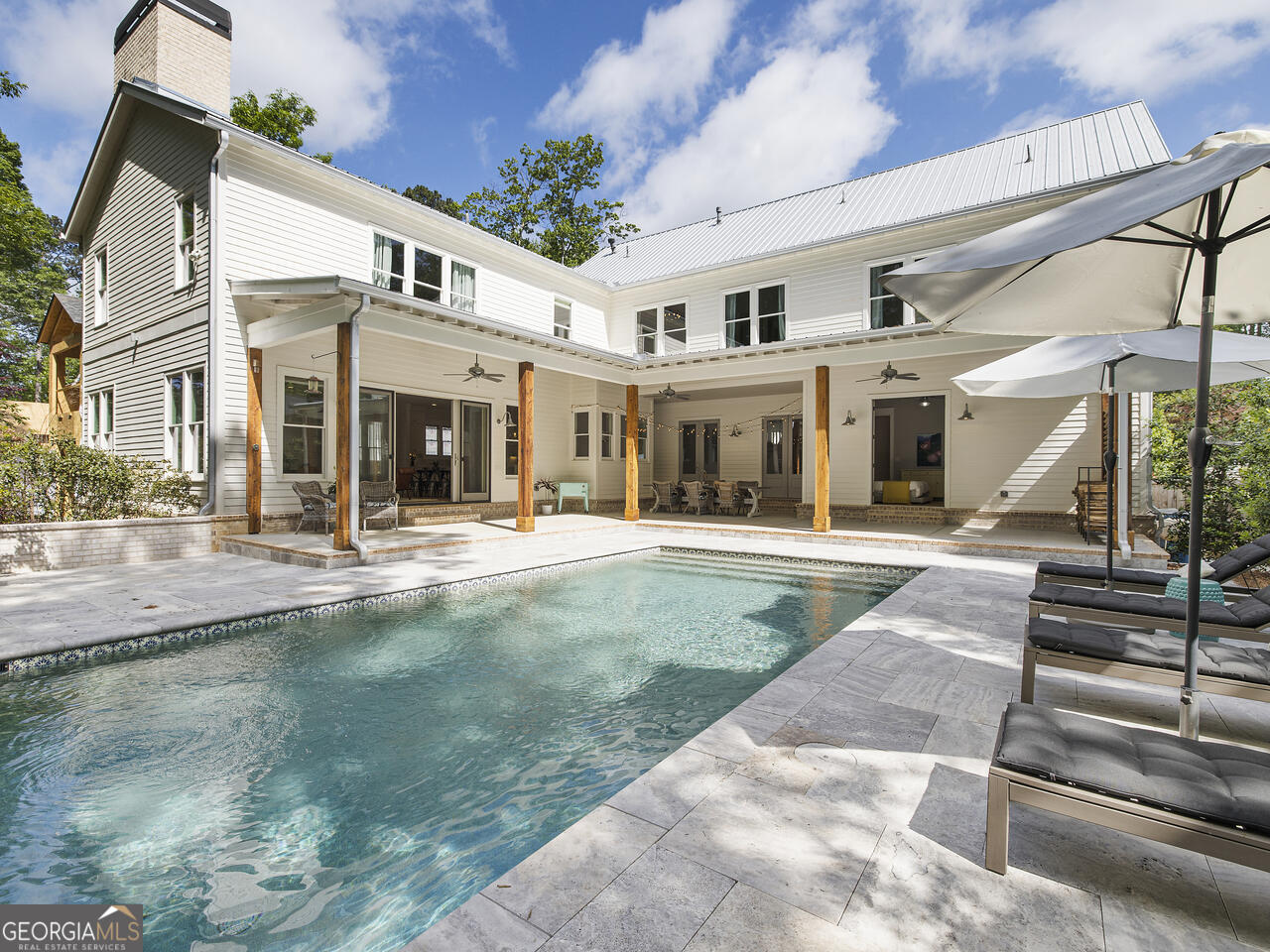 Just a few blocks from the heart of downtown Alpharetta, this home feels like a peaceful retreat that's still close to everything you love-restaurants, local shops, and live music on the weekends. It blends clean, modern design with the kind of cozy charm that makes you want to kick off your shoes and stay a while. The kitchen really is the heart of it all-bright, open, and thoughtfully designed. It features high-end appliances, stunning Carrara marble countertops, and custom cabinetry that's as functional as it is beautiful-perfect for everything from casual breakfasts to holiday gatherings. Just off the kitchen is a super practical scullery with two dishwashers, a sink, extra counter space, and a pantry, so the mess can stay out of sight when you're hosting. Throughout the home, you'll find wide-plank pine floors, exposed beams, and large, light-filled windows that give every room a welcoming, lived-in feel. Out back, it feels like a getaway of its own-double doors open to a heated saltwater pool, a spacious deck, and a pool house that's fully equipped for summer hangouts (yes, there's a bar and a bathroom out there too). On the main level, there's a guest suite with direct pool access-ideal for visitors or maybe even your own personal retreat-and another bedroom that could easily become a home office. Upstairs, the primary suite is a total sanctuary, with a spa-like bathroom, clawfoot tub, large walk-in shower, custom vanities, and two walk-in closets. You'll also find two more bedrooms, another office, and a flexible bonus space for whatever you need-playroom, studio, you name it. The basement is partially finished-perfect for movie nights or a game room-with plenty of extra space left to make it your own. If you're looking for a home that balances style, function, and a little bit of luxury-this one's worth a look.