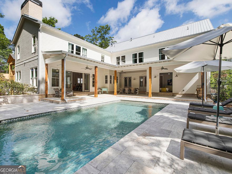 Just a few blocks from the heart of downtown Alpharetta, this home feels like a peaceful retreat that's still close to everything you love-restaurants, local shops, and live music on the weekends. It blends clean, modern design with the kind of cozy charm that makes you want to kick off your shoes and stay a while.    The kitchen really is the heart of it all-bright, open, and thoughtfully designed. It features high-end appliances, stunning Carrara marble countertops, and custom cabinetry that's as functional as it is beautiful-perfect for everything from casual breakfasts to holiday gatherings. Just off the kitchen is a super practical scullery with two dishwashers, a sink, extra counter space, and a pantry, so the mess can stay out of sight when you're hosting.    Throughout the home, you'll find wide-plank pine floors, exposed beams, and large, light-filled windows that give every room a welcoming, lived-in feel. Out back, it feels like a getaway of its own-double doors open to a heated saltwater pool, a spacious deck, and a pool house that's fully equipped for summer hangouts (yes, there's a bar and a bathroom out there too).    On the main level, there's a guest suite with direct pool access-ideal for visitors or maybe even your own personal retreat-and another bedroom that could easily become a home office. Upstairs, the primary suite is a total sanctuary, with a spa-like bathroom, clawfoot tub, large walk-in shower, custom vanities, and two walk-in closets. You'll also find two more bedrooms, another office, and a flexible bonus space for whatever you need-playroom, studio, you name it.    The basement is partially finished-perfect for movie nights or a game room-with plenty of extra space left to make it your own.    If you're looking for a home that balances style, function, and a little bit of luxury-this one's worth a look.