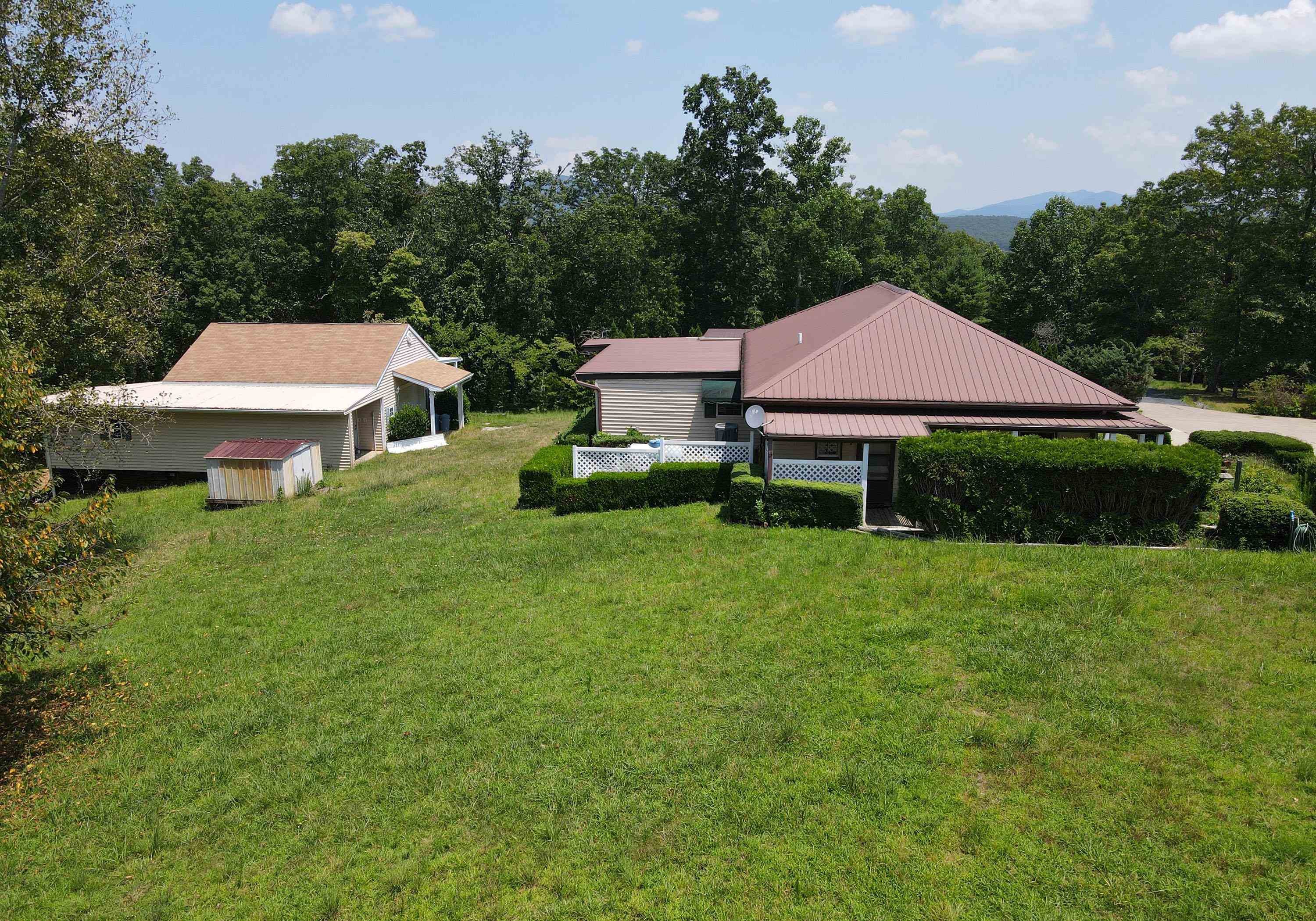 Private Estate in lake area of Nottely, Joins USFS. This 8 acre homestead offers a 2/2 home featuring an Office, Den, Dining, and open kitchen. Mix of sheetrock and T&G wood. High ceilings in bedrooms. 2 CAR carport. Lots of storage closets and rooms. Detached fabulous workshop/barn/ garage. Tractor parking area. One line of property is USFS,TVA Land. Open pasture has Fabulous long-range mountain views! Multiple building sites. Old wagon trail along the wooded property line. Public water, Easy access, Gated drive. By Appointment only.