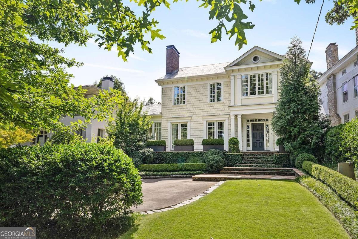 Welcome to 100 Inman Circle, a captivating residence nestled in the heart of Atlanta's prestigious Ansley Park neighborhood. This exquisite home offers an elevated living experience on one of the neighborhood's premier streets. Step inside and be greeted by the allure of modern luxury blended with classic charm. The spacious interior boasts an abundance of natural light that dances across the hardwood floors, creating an inviting and warm ambiance throughout. Large, light-filled rooms provide an ideal backdrop for entertaining, from elegant gatherings to cozy evenings with loved ones. The stunning updates throughout the home showcase a meticulous attention to detail and a commitment to quality. The gourmet kitchen is a chef's dream, adorned with top-of-the-line appliances, custom cabinetry and effortlessly combines functionality with style. The primary suite is a private retreat, offering tranquility and comfort. Indulge in the lavish en-suite bathroom featuring modern fixtures, a spa-like shower, and refined finishes that elevate your daily routine. Beyond the main residence, a walk-out backyard beckons with its manicured landscape and space for relaxation. Discover the convenience and versatility of the guest house, perfect for accommodating visitors or serving as a private studio or home office. This home offers not only a luxurious living space but also access to the vibrant cultural scene, parks, and amenities that make this area truly special. 100 Inman Circle presents an unparalleled opportunity to embrace a sophisticated intown Atlanta lifestyle.