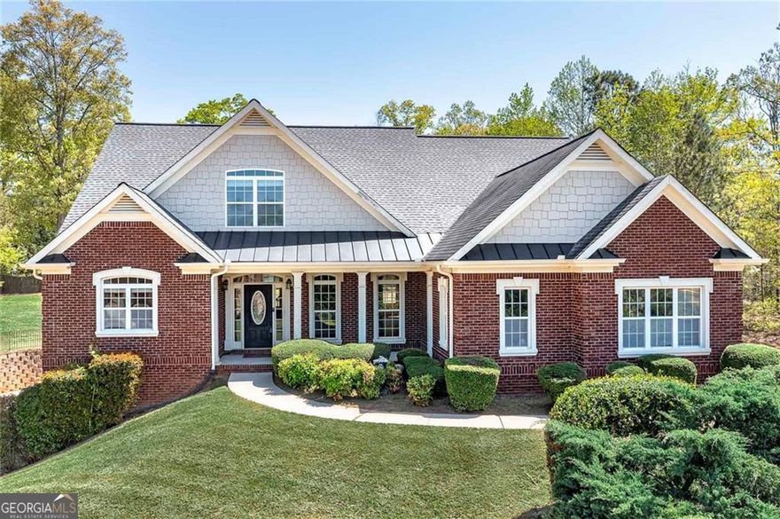 Schedule to tour this stunning 5 bedroom 5 bathroom executive style home located in the highly sought after Estates at Hurricane Pointe in Douglasville, Georgia. This former model home offers 5,126 sq ft of luxury living on a private 1.08-acre corner lot. The main level features a spacious owner's suite with a sitting room, dual walk-in closets, a spa-like bath with a soaking tub, tiled shower, dual vanities, and access to the deck for an extended indoor outdoor living of the owners suite. Enjoy a gourmet chef style kitchen with granite countertops, KitchenAid stainless appliances, double ovens, breakfast bar, walk-in pantry, and an eat-in kitchen area. The main level also includes a formal dining room, high-ceiling living room with coffered ceilings and hardwood floors, and a laundry room with washer and dryer included. Upstairs offers generously sized bedrooms, each with access to en-suite bathrooms. Finished basement includes bonus room, full bath, storm room, additional storage, and a boat door/3rd garage. Step outside to a beautifully landscaped backyard with a fenced in 20 by 40 inground sparkling pool. All pool equipment and pool furniture included. This home is convenient to shopping, parks, dining, and highways. Includes a rare opportunity 2-year home warranty... Yes a 2 year home warranty for your protection and peace of mind. Schedule your private tour today and discover everything 7804 Gusty Trail has to offer!