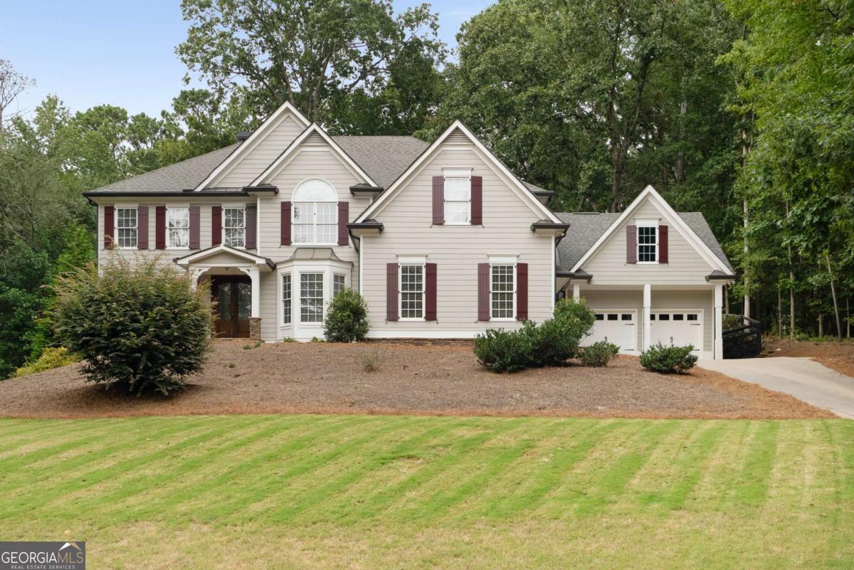 Stunning Alpharetta Home in the Sought-After Creekview High School District! Located in desirable Cherokee County, this rare find offers a seamless walk-out from the main level to a private backyard oasis. Situated on nearly one acre (.92 acres), the property features a saltwater pool, finished terrace level with full in-law suite, and a 4-car garage with exterior access to an unfinished bonus room above. Inside, beautiful hardwood floors flow throughout the main level. The spacious family room boasts floor-to-ceiling windows and a fireplace overlooking the pool and backyard. The main level also includes a guest bedroom with a full bath, a formal dining room with Butlers Pantry and a versatile living room/office. The chef's kitchen is designed with stone countertops, stainless steel appliances, a gas cooktop, walk-in pantry, and ample cabinetry. Upstairs, the expansive primary suite serves as a true retreat with a spa-like bath and a generous walk-in closet. The finished terrace level is ideal for entertaining or extended guests, offering a living area, full kitchen, and additional bedroom with private full bath. Combining style, function, and outdoor living, this exceptional home truly has it all, space, luxury, and a backyard built for relaxation and entertaining.