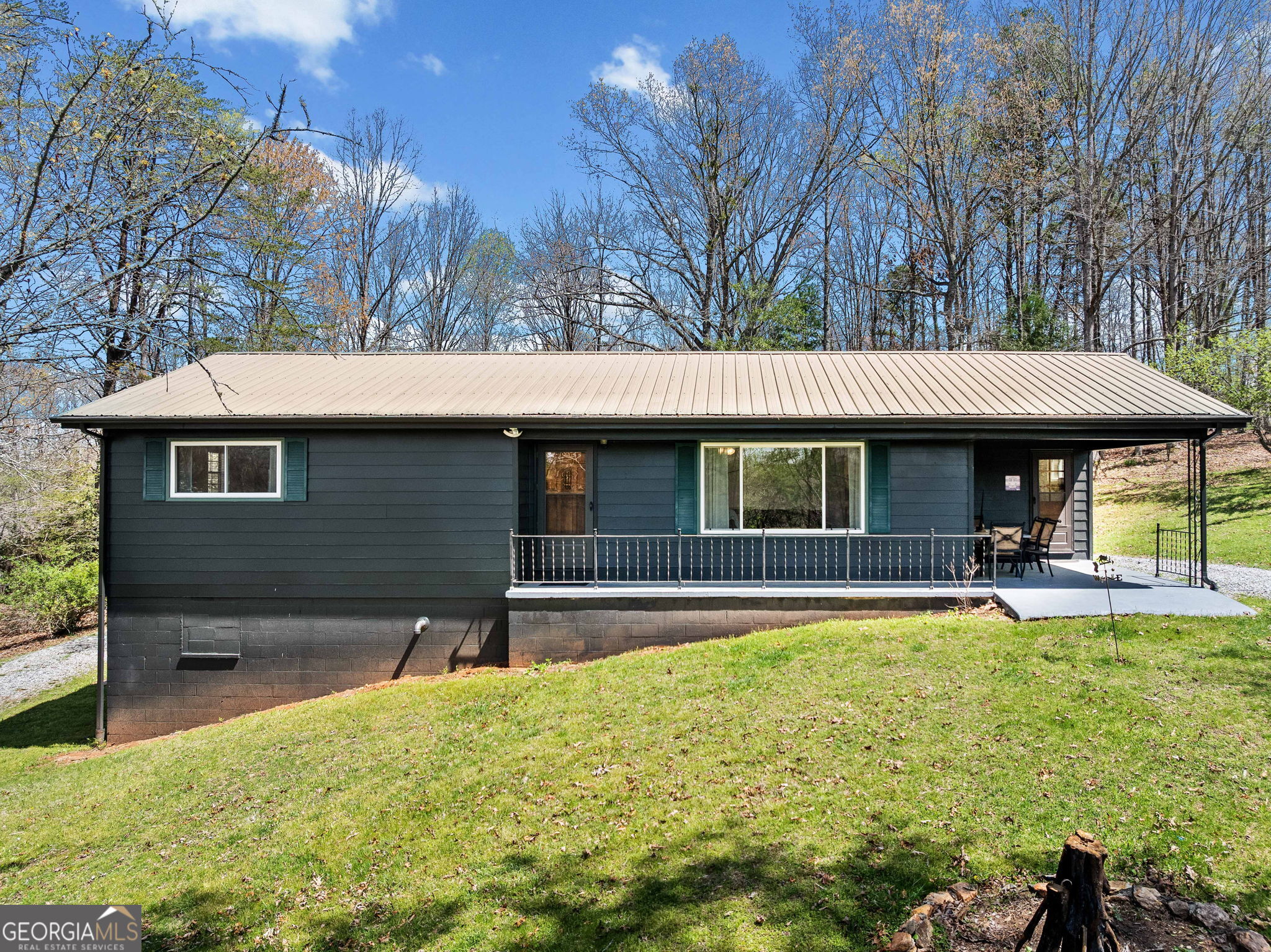 House comes Furnished. Amazing Short Term Rental ( STR ) Mountain Getaway on 2.86 Private Acres - Mineral Bluff, GA Tucked into the trees and surrounded by nature, this welcoming 3-bedroom, 2.5-bath home sits on nearly 3 acres of peaceful land in beautiful Mineral Bluff. Recently passed down through the family and now a thriving Airbnb, this home is full of charm, comfort, and potential. The single-level layout features a bright and airy living space with big windows, updated floors, and fun cabin-inspired touches throughout. The kitchen has been thoughtfully renovated with modern finishes, sleek cabinetry, and open shelves that make it feel like home the moment you walk in. Outside, the rocking-chair front porch and private back deck are perfect for soaking in the quiet woods around you. There's also a basement with a finished bedroom and bathroom and the other 3/4 of the basement is unfinished just waiting to be transformed-plus a separate workshop for hobbies or storage. And with nearly 3 acres, there's no shortage of space to explore or just enjoy some peace and quiet. Whether you're looking for a personal retreat, a full-time home, or a ready-to-go investment property, this one checks all the boxes. Just minutes from Blue Ridge, hiking, fishing, and local wineries-this is mountain living, made easy.