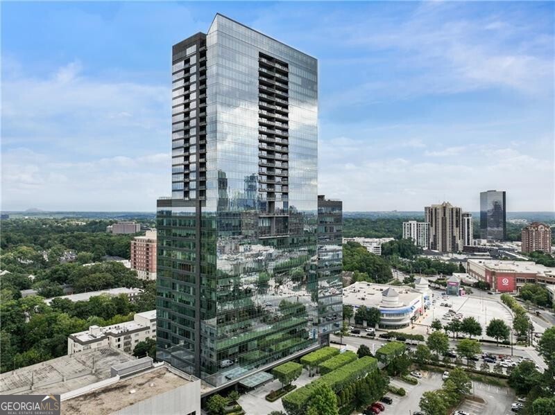 Welcome to the epitome of luxury living at Buckhead's one and only Ritz-Carlton Residences. This stunning southeast-facing corner penthouse on the 33rd floor offers 4500 square feet of contemporary elegance on a single level. Bask in the spellbinding views of the Perimeter area, Brookhaven, Buckhead, Midtown and downtown skylines, along with the majestic Stone Mountain. The expansive grand rooms, graced with 11-foot ceilings and custom oak floors, exude sophistication and style. Marvel at the bespoke lighting, automatic window shades, custom metal doors, and specialty hardware that adorn this exquisite home. The bathrooms, adorned with white Carrera marble, provide a spa-like retreat, while the all-Viking kitchen is a culinary enthusiast's dream. This penthouse features two massive living rooms, three terraces, and an over-sized mud/laundry room with ample storage and sink. With three prime parking spaces and additional storage, convenience is at your fingertips. The Ritz-Carlton Residences offer effortless, luxurious living marked by around-the-clock valet parking, valet service, pet friendly community and presidential-level security. Indulge in year-round relaxation with the outdoor heated saline pool and spa. The adjacent building houses three restaurants, providing a culinary journey right at your doorstep. Enjoy the legendary Ritz-Carlton staff who truly provide white glove service. The elegant 2 story club rooms, media room, conference room, fitness center, and two beautifully appointed guest suites enhance your lifestyle, while unlimited family and guest valet parking add to the convenience. Located on Peachtree Road, the residences are within proximity to glamorous department stores, five-star hotels, and fine dining. Experience unparalleled service, luxury, and beauty synonymous with the Ritz-Carlton name. Revel in the pinnacle of luxury living, where every detail is designed to offer a life of sophistication, elegance, and convenience. This is more than a home; it's an iconic lifestyle, a place where stories unfold, and memories are made. Welcome to your exclusive urban retreat at the Ritz-Carlton Residences, Buckhead.