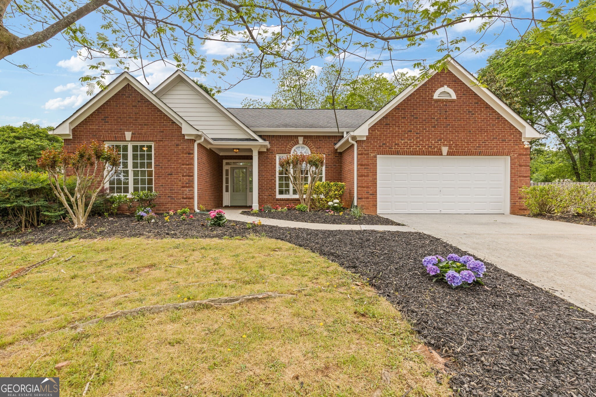 Tucked away on a serene cul-de-sac lot, this beautifully remodeled 3-bedroom, 2.5-bath ranch home in Alpharetta offers the perfect blend of modern updates and timeless charm. The interior has been meticulously renovated and feels like new, featuring an open floor plan that effortlessly combines formal elegance with casual comfort. Upon entering, you're greeted by a spacious formal dining room that flows seamlessly into the inviting fireside living room, complete with vaulted ceilings. The heart of this home is the stunning kitchen, where Taj Mahal quartzite countertops and off-white cabinetry create an elegant contrast that's both stylish and functional. The breakfast bar adds an extra layer of sophistication, making it the perfect space for family gatherings or casual meals. New lighting throughout the home enhances the modern aesthetic and adds warmth to every room. Designed for privacy, the split-bedroom layout offers a peaceful retreat in the spacious primary suite. The ensuite bath is an indulgent oasis, complete with a soaking tub, a brand-new tiled shower, double vanities with ample cabinet storage, and a generous walk-in closet. A true highlight of this home is the sunroom, which is bathed in natural light and offers the perfect space to relax, unwind, or enjoy a good book while taking in the serene views of the private backyard. Step outside to your tranquil outdoor retreat, where a charming center patio awaits, ideal for entertaining guests or enjoying quiet evenings under the stars. This home offers the perfect combination of elegance, comfort, and functionality, all in an unbeatable location.