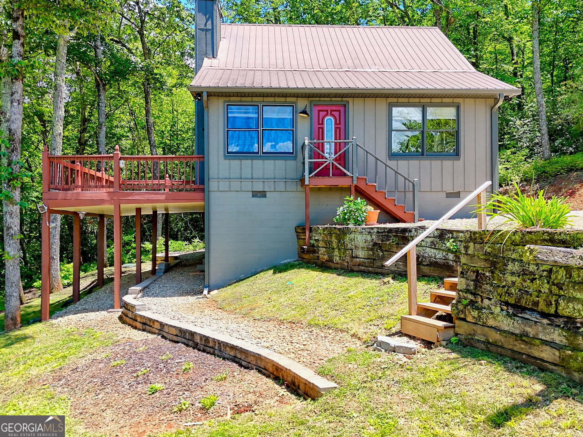 VIEWS, PRIVACY & PROXIMITY TO DOWNTOWN CLAYTON!! Nestled atop the tranquil Screamer Mountain, this charming 2-bedroom, 2-bath home offers an idyllic escape with breathtaking long-range mountain vistas and unmatched privacy. Spanning 1,332 sq ft on two lots totaling 3.1 acres, this property combines serenity with accessibility, conveniently located just 8 minutes from downtown Clayton and a mere minute off the paved main road, Warwoman. The home's positioning provides complete privacy and unobstructed, year-round views-an uncommon find at such an altitude with such a short, easy drive. Its design embraces an open house concept, perfect for those who value space and natural light. Central to the living area is a cozy wood-burning fireplace, creating the perfect ambiance for memorable evenings. The kitchen and dining area flow seamlessly together, making it ideal for entertaining guests or enjoying quiet family meals. The main bedroom, conveniently located on the first floor, features a spacious walk-in closet and an ensuite bath, offering a private and peaceful haven. Upstairs, a second bedroom with its own private bathroom provides comfortable accommodations for guests. Additional features include an unfinished basement that serves as extra storage space and a workshop with ample potential for customization. The property also includes an additional lot equipped with a 1-bedroom septic system, ready for expansion or a second home. This extra lot presents a remarkable opportunity to expand, build an additional home, or simply enjoy the extra acreage for recreational activities. This rare find perfectly blends comfort, convenience, and stunning natural beauty.