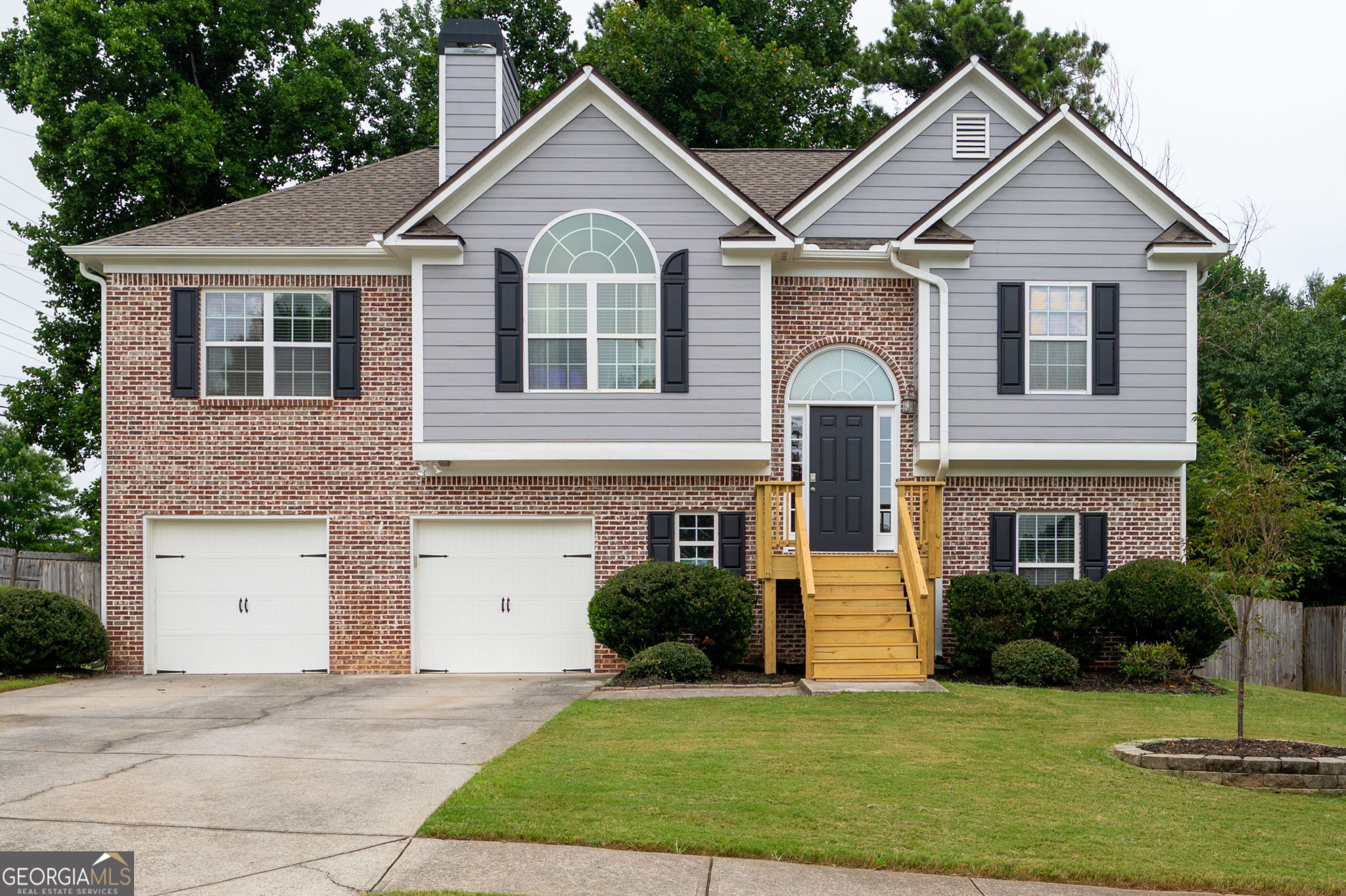 Welcome to this charming 4 bedroom, 3 bathroom split-level home in the heart of Acworth! Step into a bright, vaulted family room centered around a cozy fireplace, flowing seamlessly into the updated kitchen with white cabinets, stainless steel appliances, and a dedicated dining area that overlooks the rear deck and fenced backyard. The oversized primary suite offers tray ceilings and an en-suite bath complete with a double vanity, soaking tub, separate shower and walk-in closet. Two spacious secondary bedrooms share a full bath with a tub/shower combo. Downstairs, you'll find a fourth bedroom, full bath, convenient laundry room, and a second living space with walkout access to the patio and backyard, perfect for entertaining or relaxing! The 2-car garage offers additional storage, and recent updates include new flooring, fresh interior and exterior paint, light fixtures, landscaping and more! This home has been well cared for and is conveniently located near I-75 and the Hickory Grove Express Lane, making commuting a breeze. Enjoy being less than 2 miles from vibrant Downtown Acworth, known as "The Lake City," with its local restaurants, shops, outdoor recreational activities, active festival and events calendar, Lake Acworth, and Lake Allatoona. You're also a short drive to Historic Downtown Kennesaw, full of charm and ongoing development. This one checks all the boxes - space, updates, and a location you'll love!