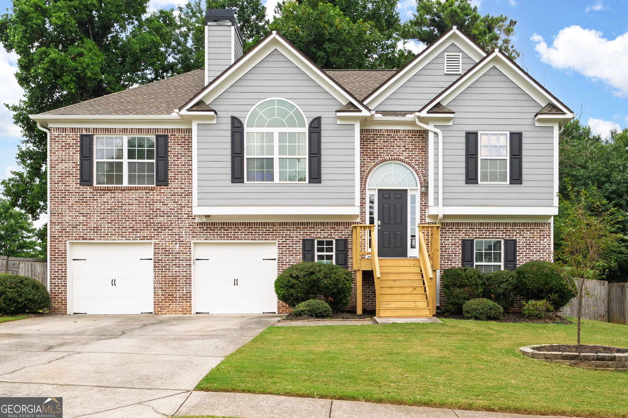 Welcome to this charming 4 bedroom, 3 bathroom split-level home in the heart of Acworth! Step into a bright, vaulted family room centered around a cozy fireplace, flowing seamlessly into the updated kitchen with white cabinets, stainless steel appliances, and a dedicated dining area that overlooks the rear deck and fenced backyard. The oversized primary suite offers tray ceilings and an en-suite bath complete with a double vanity, soaking tub, separate shower and walk-in closet. Two spacious secondary bedrooms share a full bath with a tub/shower combo. Downstairs, you'll find a fourth bedroom, full bath, convenient laundry room, and a second living space with walkout access to the patio and backyard, perfect for entertaining or relaxing! The 2-car garage offers additional storage, and recent updates include new flooring, fresh interior and exterior paint, light fixtures, landscaping and more! This home has been well cared for and is conveniently located near I-75 and the Hickory Grove Express Lane, making commuting a breeze. Enjoy being less than 2 miles from vibrant Downtown Acworth, known as "The Lake City," with its local restaurants, shops, outdoor recreational activities, active festival and events calendar, Lake Acworth, and Lake Allatoona. You're also a short drive to Historic Downtown Kennesaw, full of charm and ongoing development. This one checks all the boxes - space, updates, and a location you'll love!
