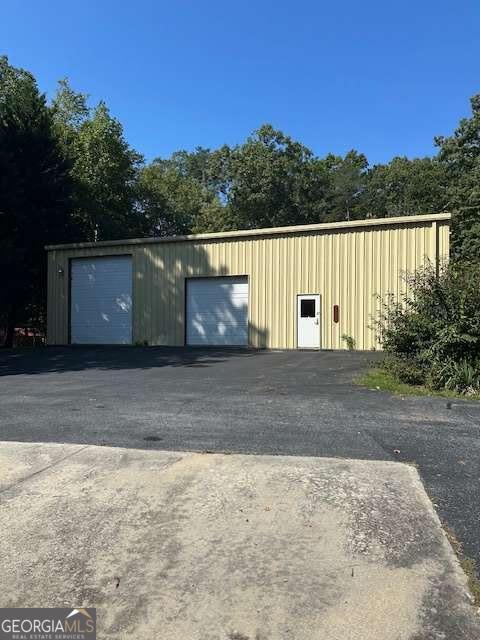 Formally Cleveland Small Engine! Property Features: 4 Sided Brick Home, 3 Bedroom, 2 Full Baths (1-tub/shower combo, 1-step in shower) Great Room, Dining and Separate Laundry/Mud Room! Garden Spot (water avail.) Within this property is an approx. 1 acre tract with approx. 60X60 Metal Constructed Building (size differs from public records) with 2-10X14 (auto drive), 2-10X10 (auto drive), 2 Walk-in Doors, Office (loft above office) Large Air Compressor, Lift, Bathroom, Electricity and Water! Great for RV, Vehicles, Etc.! 12X15 Storage Building and 11X11 Shed! Dual Asphalt Driveway! ALL Situated on approx. 3.24 acres, Private Setting, Convenient to Downtown Cleveland! (Additional Pictures Forthcoming)