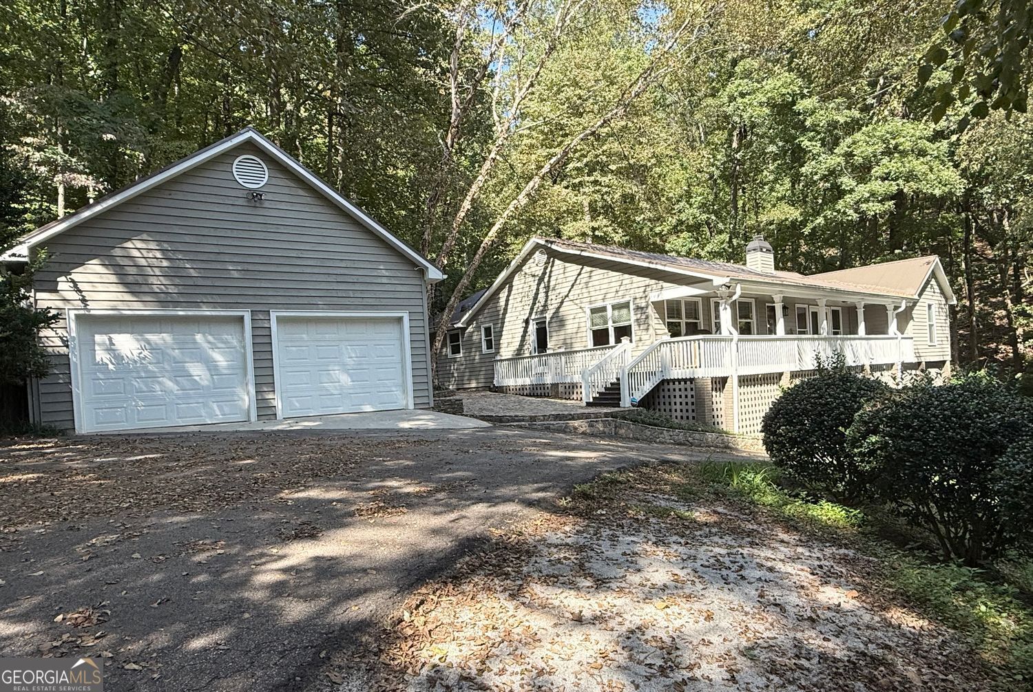 This beautiful 3 bedroom, 2 bath home on 2.99 acres boasts incredible long range mountain views from the rocking chair front porch! The spacious kitchen has quartz countertops, stainless appliances, and a separate drink station complete with drink cooler. The large living room features a brick masonry fireplace with shelving and a wall of windows/doors to enjoy the beautiful mountain views! The primary bedroom has an ensuite bathroom with dual vanities and a tiled walk-in shower with dual shower heads. Enjoy a roommate floor plan with two more bedrooms that share a bath. Other features include hardwood and tile flooring throughout, a large covered front porch, huge sunroom, spacious back deck with hot tub, circle driveway, and a detached garage with storage space above.