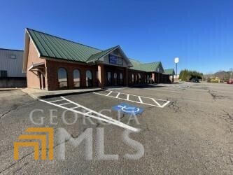 This is a FANTASTIC, income producing building with 3 corporate businesses locked in long-term leases. The stability of these long term tenants provides for any and all businessmen and women a smart investment. Currently with only 1 unit vacant, this business has a CAP rate of 6.1%! A total of 6 Units - 5 have been completely renovated in the last 3 years. All new HVAC units. This property is conveniently located on 515 but also has a back entrance to Camp Road. With the HUGE amount of growth that Pickens County has already experienced as well as what is to come... this building will be worth every penny! Interstate signage also comes with the property!
