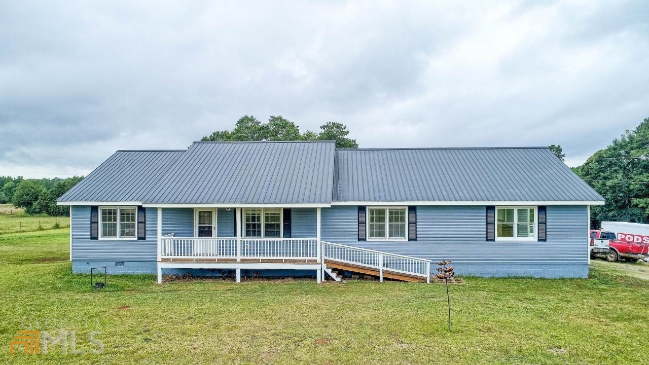 Bring your horses, cows & any other livestock to this very private farm on 65.89+/Acres located in a very desirable area of Jackson. Minutes off I-75 but worlds away from the congestion of the nearby areas. This property is fenced & cross fenced ready for your animals. The 900 sq ft Pole Barn is complete with catch pin. Another large 28x28 metal barn with 2 large roll up doors & 14x28 lean to with electricity provides you many options for equipment, hobbies, work related items, storage, etc. Along with the horse stalls, you will find a metal 12x20 shed for Tac Room or many other uses. Just when you thought there couldn't be more storage there is a 15x30 metal shed to give you more parking for your equipment, hay covered area for your ATVs and other toys, etc. The possibilities are endless. If all this wasn't enough, the property boasts not one but two creeks and a private pond. A well maintained 3BR/2BA ranch with large, country kitchen & breakfast nook leads you into a spacious dining room and living room. Not only is the Master Bedroom spacious, but the secondary bedrooms are large with lots of closet space. The rocking chair front porch overlooks the front pasture. The house has a 10x20 enclosed porch complete with heating and air that is a great flex space for an office, play room, sun room, etc. An extra utility space is located inside the garage. The property is serviced by a well but county water is at the property ready to be hooked up. All of the property except for two acres around the house is in Conservation, which expires at the end of 2025. ***FIBER OPTIC INTERNET & PHONE will be operational by mid-July. See Virtual Tour Link for Drone Footage & 3D Tour.