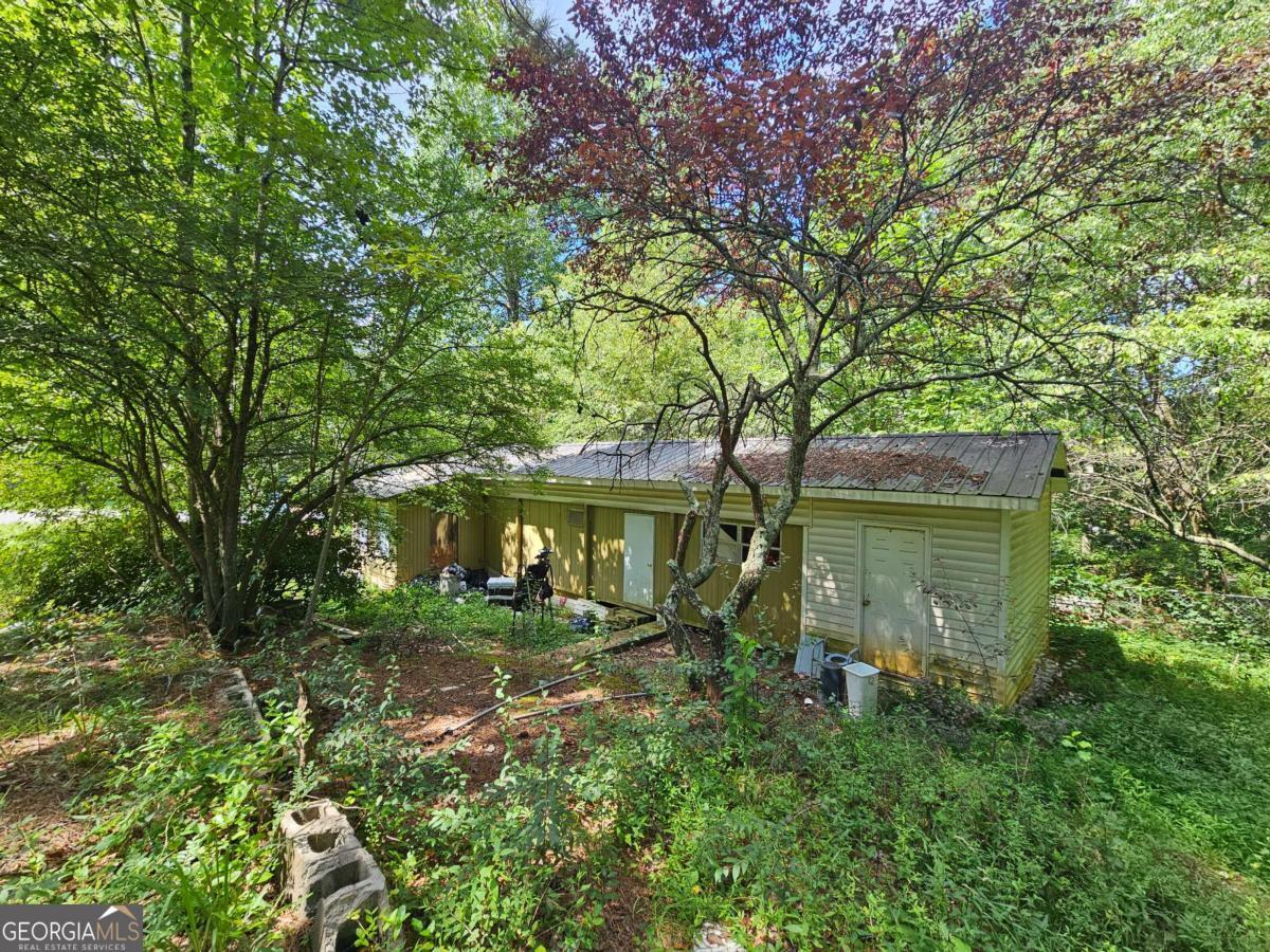 The mobile home sits on two lots, offering added privacy, expansion potential, extra outdoor space for entertaining or possibly an additional home. Don't miss this chance to invest in a property with rare lake access and resort-style amenities. Community amenities including a boat ramp, dock access, swimming pool, tennis courts, and a playground-all just a short walk away. Whether you're into fishing, boating, or simply relaxing by the water, this property delivers it all. Cash only, this home will not qualify for any type of loan. Owner occupied, appointments only.