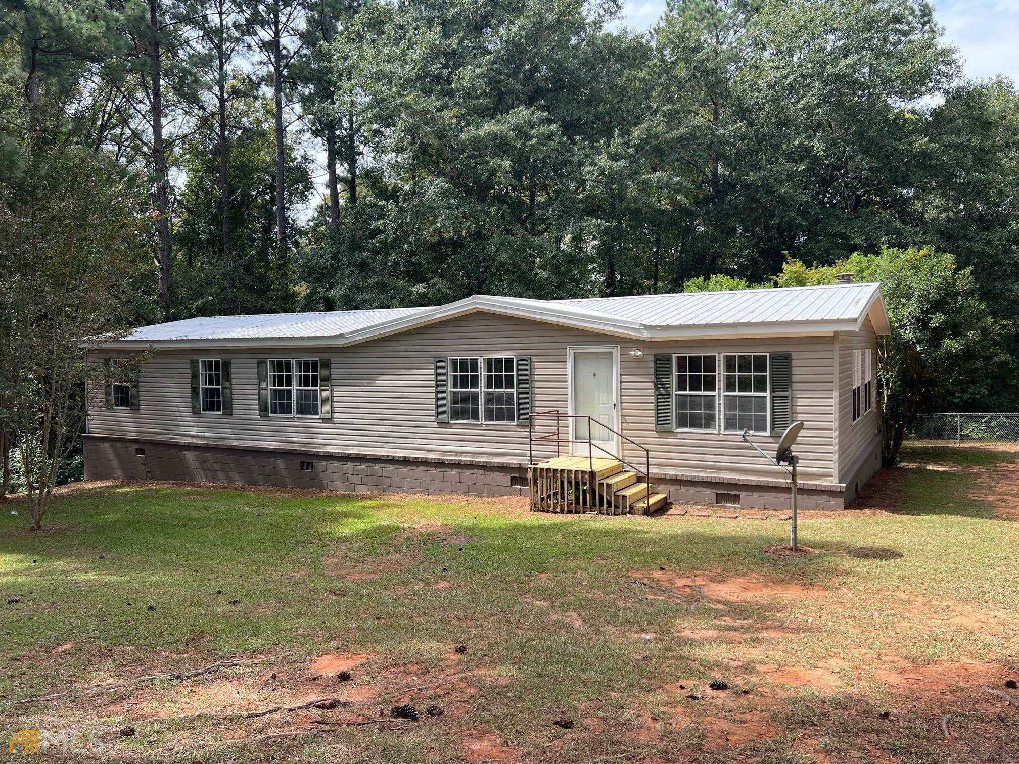 Remolded 1997 Horton Homes mobile home situated on 2.62 acre lake lot. Fresh paint, new flooring, vanities, and light fixtures. Fenced in back yard with 10x12 storage building. Approximately 100 ft of lake frontage (East Lake). Recreational fishing lake, electric motors only. Great home close to town! Call to schedule your showing today.