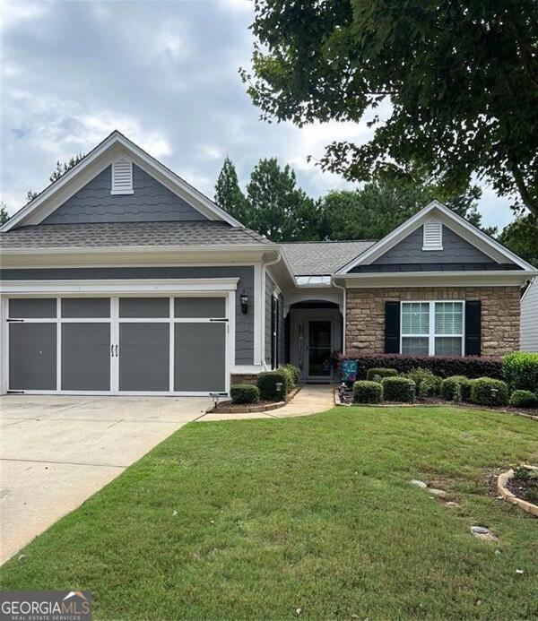 Located in the highly sought-after active adult community of The Village at Deaton Creek, this beautifully maintained 2-bedroom, 2-bath ranch home offers a blend of comfort, style, and low-maintenance living. Step inside to an open-concept floorplan with all hardwood floors on the main level, a cozy fireplace in the living room, and an inviting sunroom that overlooks a lush, fenced backyard featuring Emerald Zoysia sod, custom rock flower beds, an extended patio, and a covered back porch-perfect for enjoying quiet mornings or entertaining friends. The home includes a separate study ideal for a home office, hobby room, or flex space. The kitchen is a chef's delight with stainless steel appliances, granite countertops, pull-out cabinet shelves, and solar tubes that add natural light to the space. The primary suite is a peaceful retreat with backyard views, dual vanities, a make-up counter, separate shower, and a spacious walk-in closet. Additional features include: Architectural roof installed in 2021 UV air purification system added to HVAC ducts Solar tubes in kitchen and bath for natural light Irrigation system in Front and Back Yard Two-car garage Enjoy the unparalleled amenities that Deaton Creek is known for-indoor/outdoor pools, tennis, pickleball, walking trails, fitness center, and over 100 clubs and activities. Just minutes from Northeast Georgia Medical Center, shopping, dining, and all the conveniences of Braselton and Hoschton. Don't miss your chance to live in one of North Georgia's most desirable 55+ communities!