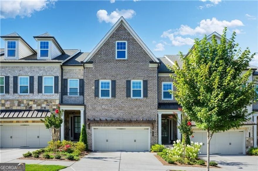 Meticulously maintained townhome nestled within the highly sought-after gated community of Harlow.  This move-in ready residence boasts a spacious three-level floorplan complete with elevator shaft for future accessibly, plus a convenient main-level two-garage, separate dining room, great room with fireplace and two outdoor spaces perfect for entertaining.  The open-concept kitchen is bright and airy with quartz countertops, white cabinetry, subway tile backsplash, breakfast bar, walk-in pantry, gas cooktop, and stainless-steel appliances.  The second level is home to the primary's private retreat with a separate sitting room - ideal for a home office, reading nook or a cozy media space.  The spa-like ensuite bathroom features a walk-in shower with bench, soaking tub, dual vanities with quartz countertops, and custom walk-in closet.  Two additional bedrooms, a full hall bathroom, laundry room with cabinetry and an oversized linen closet complete this level.  The finished terrace level is a versatile space currently serving as a secondary family room and home office. However, the possibilities are endless and can easily be transformed into a fourth bedroom in addition to a media room, a playroom, a rec room, or a home gym!  This level also includes a full bathroom, ample storage and direct access to a patio with a fenced grass yard.  Resort-style amenities include two pools, tennis/pickleball courts, trails, a dog park, a lake, a community garden and clubhouse.  Plus, its prime location offers unbeatable convenience to GA-400, Ameris Amphitheater, Downtown Alpharetta, North Point Parkway and Avalon.  Imagine yourself at 11 Ganel Lane!