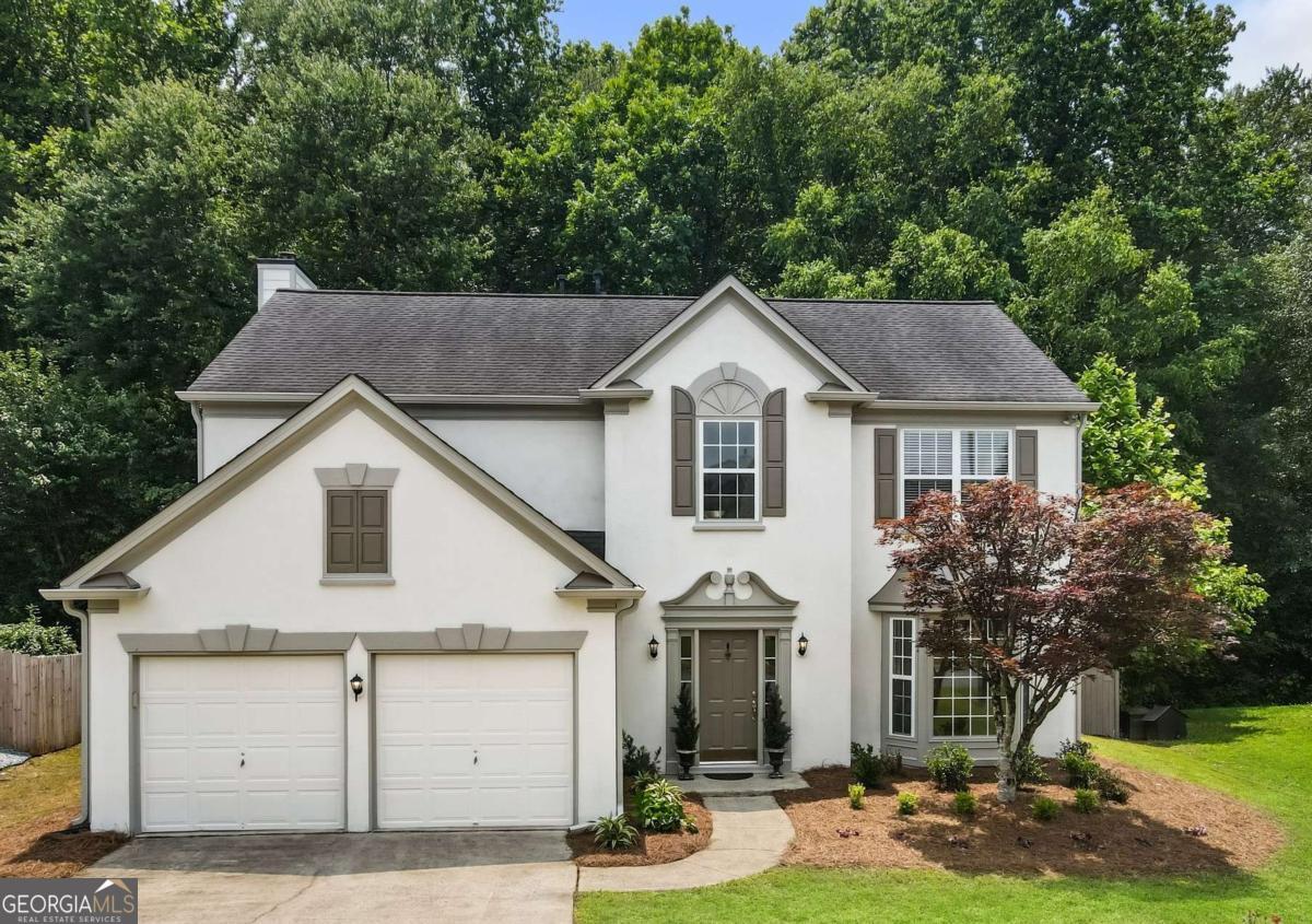 Tucked away in one of Woodstock's most desirable swim and tennis neighborhoods, this well-maintained 4-bedroom, 2.5-bath home sits on a premium, fenced lot with a freshly painted interior and exterior, adding to its welcoming ambiance. Step inside, and you'll find a great mix of space and comfort. The two-story foyer opens to a formal living room that seamlessly flows into the dining room, ideal for family dinners or special gatherings. The heart of the home is the open-concept kitchen, featuring a breakfast area that connects to a spacious family room with a cozy fireplace. This room is perfect for movie nights, casual gatherings, or simply relaxing at the end of the day. The kitchen is designed for both style and function, featuring granite countertops, a center island, and ample cabinet space. Upstairs are four bedrooms, including a spacious primary suite with a vaulted ceiling, a walk-in closet, and a private bath featuring double vanities, a soaking tub, and a separate shower. There is also a full hall bath with double sinks, as well as a laundry room conveniently located on the same level. Out back, you'll love the private fenced yard with a peaceful wooded backdrop. The extended patio with a pergola is an excellent spot for enjoying your morning coffee, hosting weekend BBQs, or simply relaxing and taking in the fresh air. This move-in-ready home offers space, charm, and a relaxed lifestyle in one of Woodstock's most sought-after communities.
