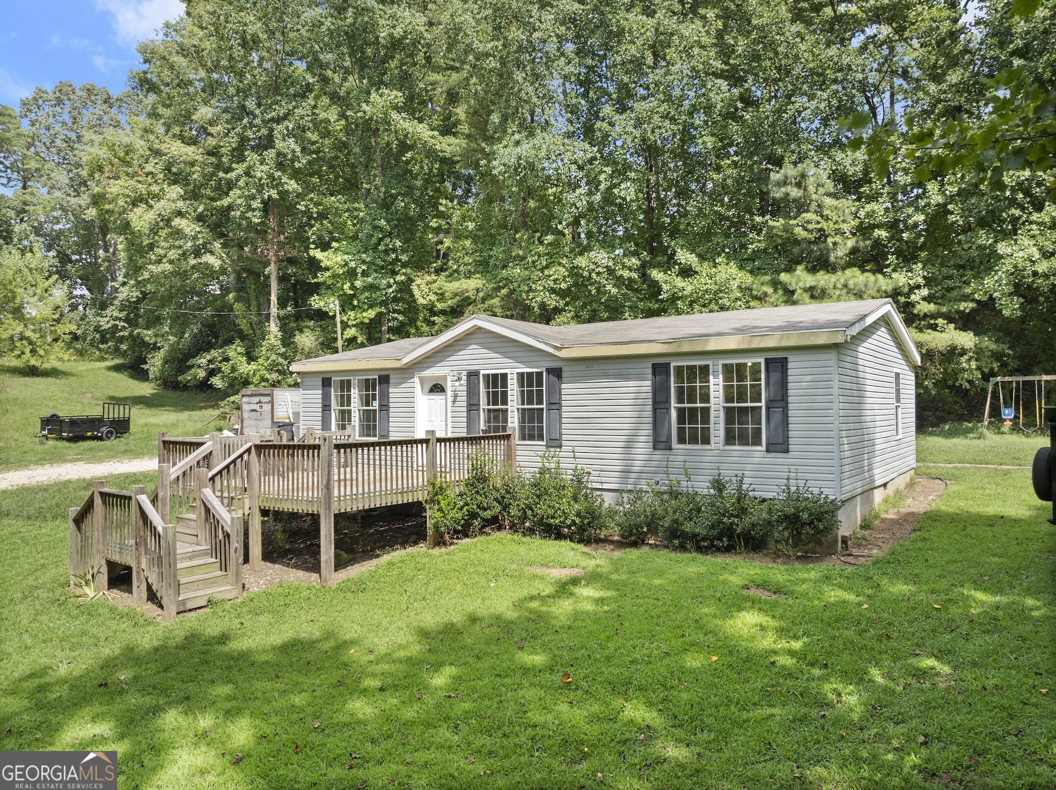 Welcome to your charming retreat nestled on 0.87 acres of serene countryside. This spacious double wide mobile home boasts modern comfort and convenience, situated on a permanent foundation.Step inside to discover a recently remodeled interior featuring 3 bedrooms and 2 baths, offering ample space for relaxation and everyday living. The home's open layout creates a seamless flow from the cozy living area to the well-appointed kitchen, perfect for both entertaining and daily gatherings.Outside, enjoy the expansive and clear front yard, ideal for outdoor activities and enjoying the fresh air. With well water available, you'll experience the benefits of a self-sufficient water supply.  Located in the highly sought-after North Hall school district, this property offers the perfect blend of peaceful rural living with proximity to excellent educational opportunities. This home qualifies for a USDA loan, allowing you to purchase with $0 down payment, making homeownership more accessible.  Do not miss your chance to own this delightful mobile home in a picturesque setting. Schedule your showing today and envision the possibilities of making this tranquil retreat your new home sweet home.