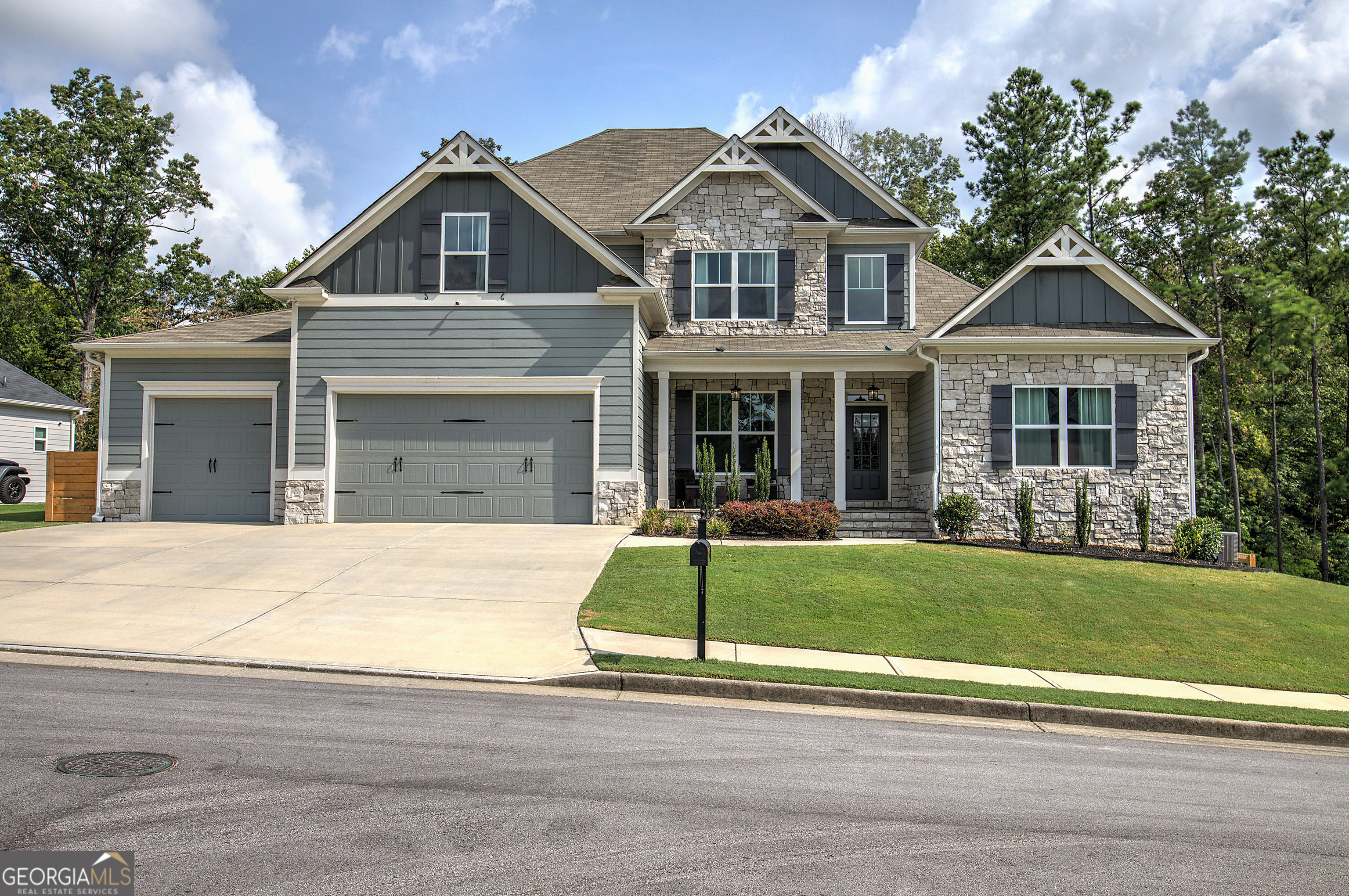 Welcome home to this gorgeous property in the highly sought-after Farm at Edenwood! Better than new, this home blends luxury and comfort with all the upgrades you could want. It features 6 bedrooms, 4.5 bathrooms, a huge 3-car garage, a fully finished basement, and a screened-in back porch with a stone fireplace overlooking the large fenced backyard and peaceful woods behind. Step inside the two-story foyer and immediately notice the hardwood floors, beautiful millwork, and attention to detail throughout. The open layout flows perfectly, with a dream kitchen that has quartz countertops, a massive island, subway tile backsplash, white soft-close cabinets, upgraded appliances, and a huge walk-in pantry. The kitchen opens to the family room, which features a stone and shiplap fireplace, coffered ceilings, and hardwood floors. From here, a door leads to the screened porch-perfect for relaxing or entertaining. Just off the kitchen, there's a convenient drop zone and laundry room that connect to the 3-car garage. On the other side of the foyer, the formal dining room makes a beautiful impression with transom windows, judges paneling, and coffered ceilings. The owner's suite is a true retreat, with a double tray ceiling, crown molding, a spacious walk-in closet, and a spa-like bathroom featuring a large tiled shower with seamless doors, soaking tub, dual vanities with stone countertops, and ceramic floors. Both the main floor and back porch have a Sonos sound system for added enjoyment. Upstairs, you'll find a flexible loft that can serve as an office or study area, along with four spacious bedrooms and two full bathrooms. The fourth bedroom is extra-large, perfect for a media room, teen hangout, or playroom. The recently finished terrace level adds even more space for entertaining, with two living areas, an office, a large bedroom with a full bath, and plenty of storage. It also opens to the rear patio, lawn, and backyard. Living in the Farm at Edenwood means access to amazing community amenities, including a clubhouse with fitness center, a triple water park, Jr. Olympic pool, waterslide with plunge pool, zero-entry pool, lighted tennis courts, and a playground. Nearby recreation includes Governor's Towne Club, Lakepoint Sports Complex, Lake Allatoona, Lake Allworth, horseback riding at Moonlight Stables, and Bentwater Golf Club. You're also close to shopping and dining on Cedarcrest Road, Acworth, Hiram, and West Cobb, as well as nearby health facilities. Located in a top-rated school district, this home is a must-see!