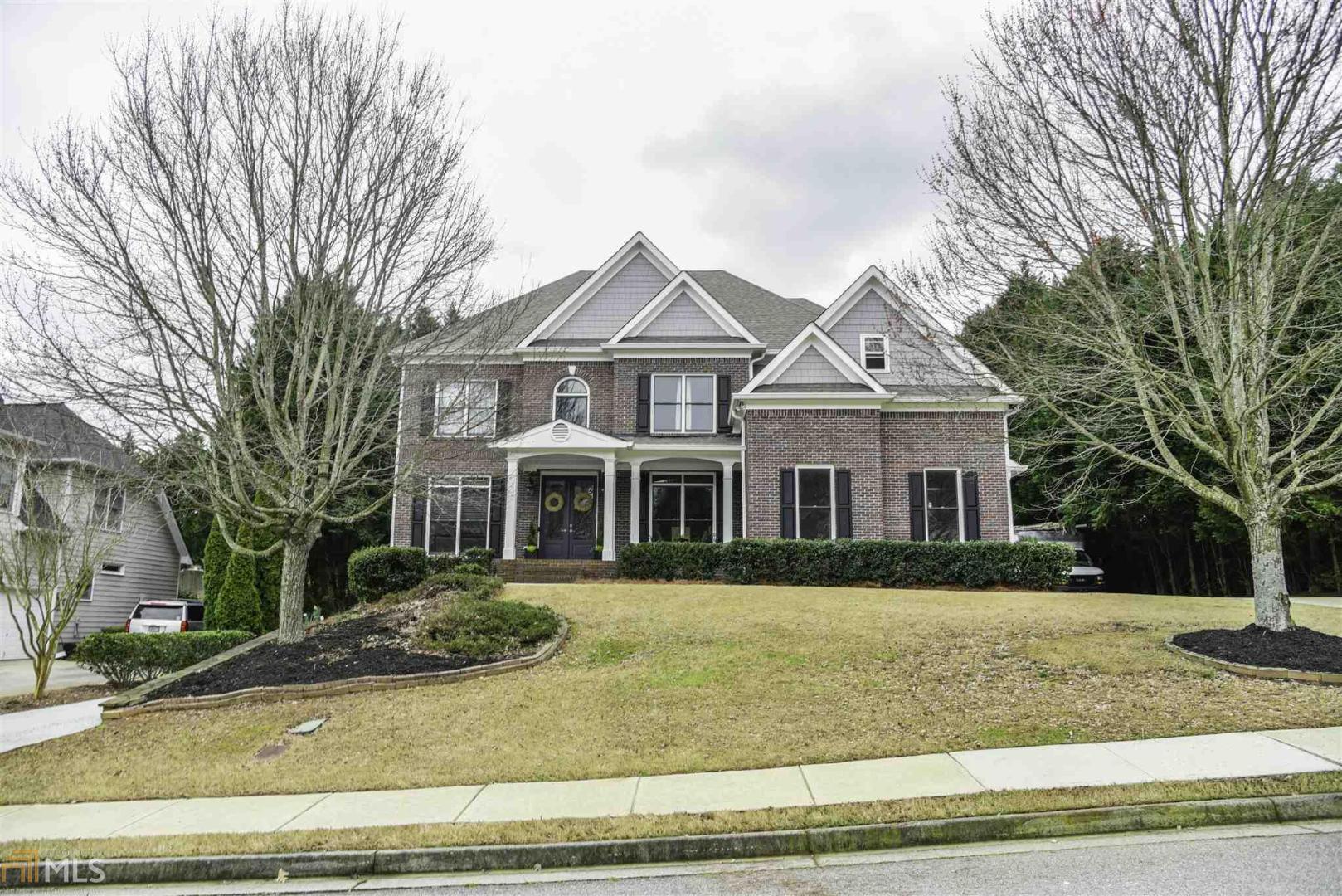 Luxurious 6 bedroom, 5 full baths home w/ finished terrace level w/ it's own driveway. Grand 2 story entrance, formal living room, dining room & family room opens to tremendous chef's kitchen w/ over-sized kitchen island, white cabinets, marble countertops, high-end stainless steel appliances - an entertainer's dream! Hardwood flooring throughout home. Large secondary bedrooms. Spacious master bedroom & en suite w/ double vanities, separate tub/shower, marble tile floors and huge master closet. Lots of windows bring in ample natural light. Incredible Suwanee location! Minutes from Suwanee Town Center, shopping, dining, award-winning schools.