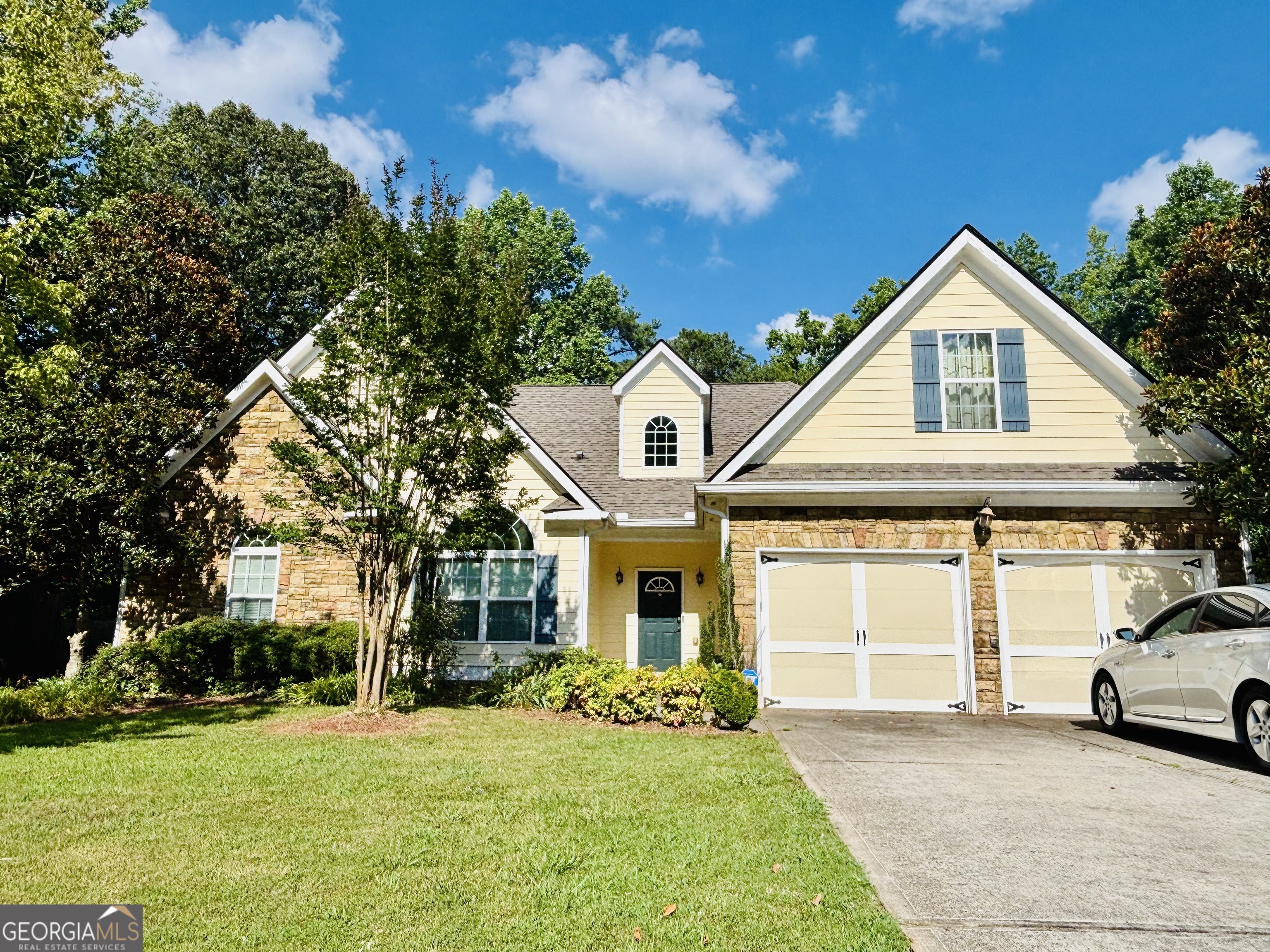 Enjoy one-level living with space, style, and flexibility in this beautifully maintained 3-bedroom, 2-bathroom home located in a quiet, established Douglasville neighborhood. Step inside to discover soaring vaulted ceilings, a spacious formal dining room, and an open-concept layout filled with natural light. The heart of the home features a modern kitchen with stainless steel appliances and plenty of counter space, flowing easily into the main living area-perfect for entertaining or relaxing at home. A large sunroom offers the perfect flex space for a home office, playroom, or second living area. Off the oversized primary suite, you'll find a bonus seating area ideal for a nursery, office, or reading nook, plus a private en-suite bath with dual vanities and step-in shower (no tub). Enjoy peaceful mornings or evenings on the screened porch overlooking the backyard.