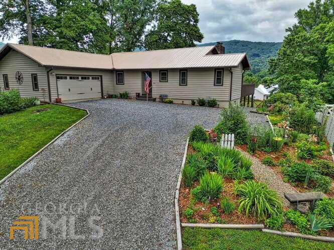 Majestic Year-Round Mountain Views and golf course at Brasstown Valley Resort. In July, also watch fireworks from your living room, screened porch, or back deck. Master on Main. Full finished walk-out basement with one bedroom and a full bath PLUS bonus rooms for office, media room, or workshops. Many options! Meticulously maintained & upgraded home priced below April 2022 appraisal! Homeowners have a binder full of receipts & warranties to provide to the new homeowner. This home has it all including a large landscaped fully fenced in back yard (new fence 2021), metal roof w/ recent maintenance, one new Trane HVAC (2019), septic updated (2019), 18 new vinyl windows (2022), new 7X7 shed (2021) built onto back of two-car garage, new BOSCH stainless dishwasher (2018), new garage door (2019), Leafless Gutter Guards (2017), & new water heater (2020). Exterior of home painted (2019) and much more!