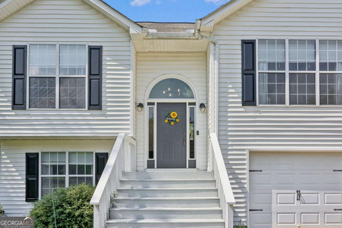 Welcome to this beautifully maintained 3-bedroom, 3-bath split-level home with a bonus room, ideally located in Central Forsyth County just minutes from the Cumming City Center! With no HOA, this property offers the freedom to truly make it your own. Step inside to an inviting, light-filled layout featuring a spacious living area and an updated kitchen with stainless steel appliances, ample cabinetry, and a convenient breakfast bar. The open dining area leads directly to the back porch, creating a perfect flow for indoor-outdoor living. The master suite includes an en-suite bath with a large shower and dual vanities. Two additional bedrooms and a versatile bonus room provide plenty of space for family, guests, or a home office. Enjoy recent updates including a brand-new front porch, newer HVAC system, and newer water heater giving you peace of mind for years to come. Step outside to your private backyard oasis featuring a cozy firepit overlooking stunning views of Sawnee Mountain the perfect spot to relax or entertain. Centrally located near top-rated schools, shopping, dining, and major commuter routes, this home offers unbeatable convenience with no HOA restrictions. Don't miss this rare opportunity in one of Forsyth County's most desirable areas!