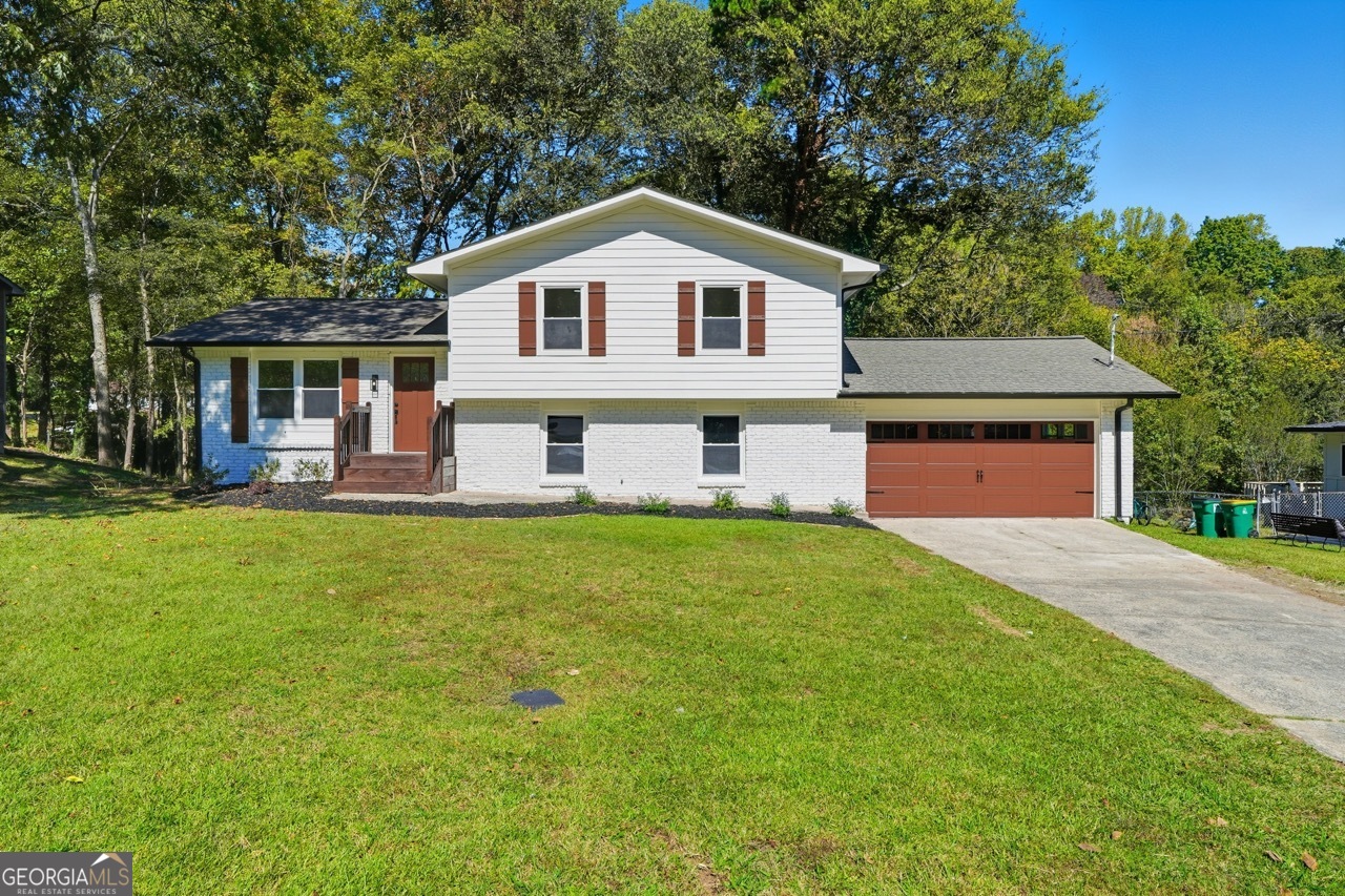 What an amazing opportunity! Fully Renovated Inside and Out, Move-In Ready, Minutes to Downtown Woodstock, and in Top Rated Cherokee County School District! This lovely three bedroom, two bath home sitting on a generous half-acre lot has it all, and NEW is the key word! Step inside to new wood flooring, new staircases, all new interior doors, smooth finish walls and ceilings, new baseboards and trim, new paint, new recessed lighting, light fixtures, ceiling fans, outlets and switches. The spacious eat-in kitchen has all new ceiling height cabinets, new stone counters, subway tile backsplash, new sink, faucet, and stainless range, dishwasher, and refrigerator. Both bathrooms have been completely updated with all new flooring, fixtures, and plumbing! The new Low-E double pane windows throughout the home come with a lifetime warranty! The basement has new epoxy flooring throughout, and a new mudroom/laundry has been created including storage cabinet and custom folding table, storage bench, and a shiplap feature wall with hooks for all of your gear! Parking is never a problem with a two-car garage with new automatic opener, extra lighting, and new epoxy flooring. Exterior renovations include new siding, trim and paint, new windows and doors, new deck and front porch, and new landscaping. The roof is less than five years old and has been professionally inspected. Come and experience the Woodstock lifestyle in this low-maintenance home!
