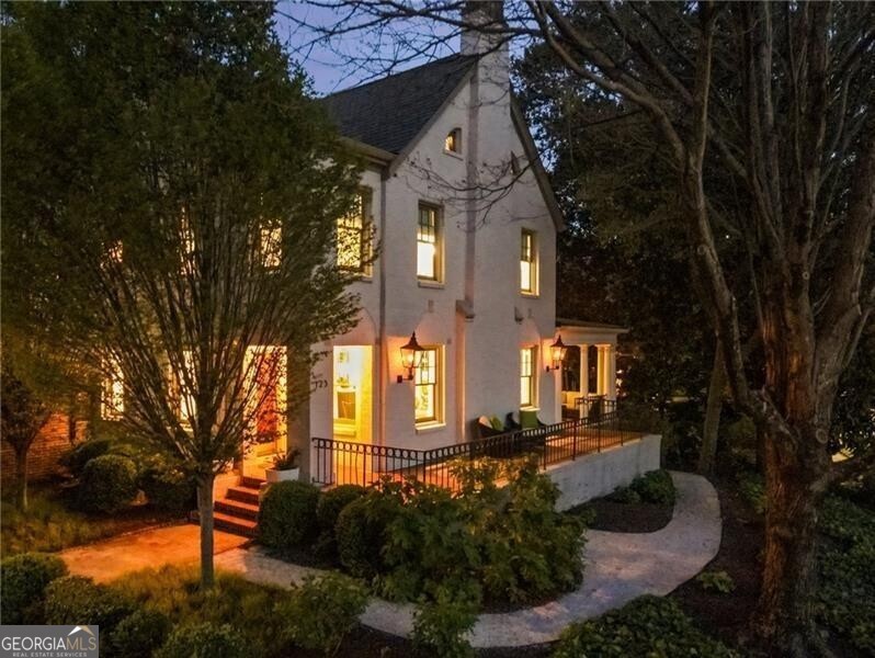 Simply magnificent! Located in coveted Ansley Park, this stunning home occupies a noteworthy position on a premier corner lot where 17th Street meets Peachtree Circle! Meticulously renovated and expanded in 2017 by the current owners who brought together architect, Stainback-Hess Studio, builder, Horner Homes, and landscape architect, Jay Winters with Elatum Designs to create a true tour de force! Warm and inviting, the home features all of the modern-day amenities while retaining its historic charm. The beautiful entry foyer leads to the oversized formal living room with gas fireplace and gorgeous moldings. Designed to entertain, the formal dining room with French doors connects the living room with the fully updated chef's kitchen that opens to a beautiful modern 2 story vaulted family room with wood burning fireplace! In addition, the main level boasts a stunning music room or study with built-ins and fabulous views of the lush garden. The luxurious primary suite is located upstairs and boasts a large walk-in closet and fully updated bathroom with dual vanities, soaking tub and extra-large shower. In addition to the primary bedroom, you will find 3 sizable ensuite bedrooms with great closets and fully updated bathrooms, a laundry room and permanent steps to a fully floored attic with tons of additional storage! The large terrace level features 1 bedroom, 1 full bathroom, a large living room offering natural light, a gym room and a tremendous amount of storage! Wait , there is more - above the attached 2 car garage sits a 2-bedroom, 1 full bath in-law/nanny suite! Other amenities include the following: tons of natural light, front and back staircases, hardwoods throughout, gas lanterns, a dog run, fully gated off-street parking for additional cars and multiple outdoor entertaining areas with some of the most spectacular views you'll find in-town! Located within walking distance to Piedmont Park, Beltline, Colony Square, Peachtree Street, ASO, Piedmont Driving Club, Ansley Golf Club, Arts Center station and all of Midtown. This special home presents the very best in quality, style and design -- every detail is perfection! Truly a rare opportunity for you to have it all in Atlanta's premier in-town neighborhood.