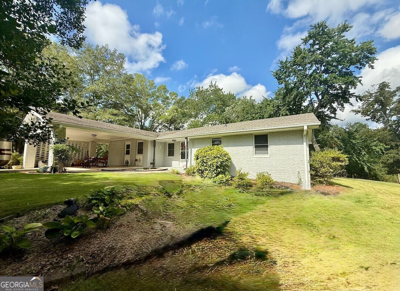 Welcome to this spacious 3-bedroom, 2-full bathroom home situated between the highly sought-after Villa Rica community, conveniently located near I-20 and downtown Carrollton. This private property sits on a generous 2-acre lot and offers the perfect blend of space, functionality, and outdoor enjoyment. Step into a welcoming open floor plan that includes a formal living room, dining room, and kitchen, ideal for hosting gatherings. The open-concept family room features a cozy fireplace and flows seamlessly into the kitchen, which boasts new LVP flooring, stainless steel appliances, and a gas cooktop, making it the heart of the home. This ranch-style home offers a main-level primary suite connected to an updated bathroom featuring granite countertops, updated cabinetry, a walk-in tiled shower, and new flooring. Two additional bedrooms share a well-appointed full bath. Fresh paint throughout the home adds a bright, updated feel. The main-level laundry room, conveniently located near the kitchen, enhances everyday living. Enjoy the outdoors with a large back deck and a covered front patio. Additional features include extra driveway space for guest parking and a storage shed for tools and gear. Also located on the property are two additional storage sheds and a small standalone rental home, perfect for an in-law suite or income opportunity. This property has no HOA and offers exceptional privacy! Conveniently located near shopping, dining, and parks, this home is priced to sell and ready for you to make it your own. Seller is offering a 1-year home warranty (up to $600) to the buyer with an accepted offer. A 45-day closing is required with the seller's preferred closing attorney, Weissman.