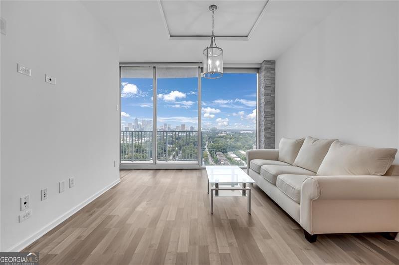 Once upon a time, you dreamed of living above the noise- high enough to see the city move, close enough to feel part of it. Live above it all at TWELVE Midtown Residences. Twenty-three floors up, this expansive 830 sq ft one-bedroom condo offers skyline views, clean lines, and the kind of atmosphere that makes you exhale the second you walk in. Inside, it's a blank canvas-but the elevated kind. New flooring. Cool stone pillars. White ceilings (no exposed concrete). A renovated bathroom with updated finishes. Natural light that follows you to the kitchen to the living space to the balcony. It's open, minimal, and lets your style (and ambition) take the lead. Downstairs, you've got everything: A 24-hour concierge. Olympic-sized pool. Fitness center. Club room. Valet. Secure parking-the works. Need coffee? Lazy Llama's downstairs. Groceries? Publix is literally next door. Forgot something? Target is across the street. Ready for a full space refresh? IKEA is steps away. Atlantic Station is your neighborhood-and it's made for movement. Whether you're working, walking, brunching, lifting, or just being-everything is right outside your door. And when it's time to explore? You're minutes from MARTA, I-75, and I-85. You can walk to SCAD or Georgia Tech, or hop into the heart of Midtown with ease. You're connected, but grounded. In the mix, but above the chaos. Exactly where you're meant to be. Come see what it feels like-23 stories above it all.
