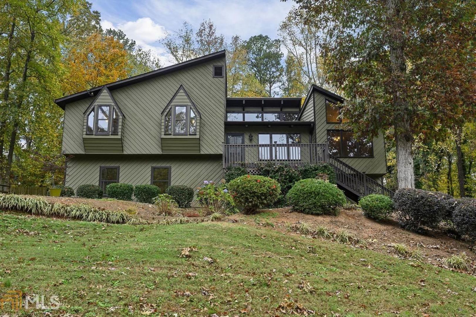 Welcome home to this charming residence wonderfully located in Kennesaw. Enter the living room to discover a plethora of natural sunlight flowing gracefully through breathtaking clerestory windows, complementing the wooden vaulted ceiling and cozy stone fireplace. The formal dining room showcases gable windows and plenty of room for easy entertaining. The chef's kitchen boasts stainless steel appliances, plenty of counter space and a delightful breakfast nook. Relax and unwind in the spacious primary bedroom that hosts an en-suite bathroom with a separate bathtub and shower. Below, discover the finished basement, adding even more living and entertainment space, as well as a private guest suite. Outside, the large deck overlooks the expansive, fenced backyard. Enjoy the fantastic location near Kennesaw State University, the Commons at Chastain, Town Center at Cobb and Kennesaw Mountain National Battlefield Park, as well as easy access to I-75 and I-575.