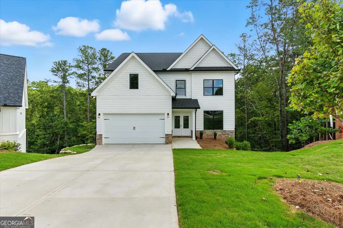 Welcome Home to 29 Creekview Drive! This stunning Alexander floor plan is nestled in a peaceful cul-de-sac and boasts an expansive layout, perfect for modern living. Featuring 4 spacious bedrooms, 2.5 bathrooms, and an open-concept design, this home is made for comfortable family living and entertaining. The Great Room showcases a cozy gas log fireplace, perfect for cool evenings. The chef-inspired kitchen is a dream, with sleek quartz countertops, high-end soft-close cabinetry, a large island, and a dedicated breakfast area. Host family gatherings in the formal dining room or step outside onto one of the two oversized back decks to enjoy the scenic views and serene surroundings. Upstairs, the master suite is a true retreat, featuring a tray ceiling, a private sitting room, and an ensuite bath with a double vanity, glass shower, and oversized walk-in closet. Three additional generously sized bedrooms share a full hall bath, and the laundry room is conveniently located on the second floor. The home includes a full unfinished basement, offering endless potential for expansion or storage. The two-car garage comes equipped with openers for your convenience. This home is nestled in the highly sought-after Carter Grove community, a golf cart-friendly neighborhood with luxurious amenities such as a clubhouse, swimming pool, tennis courts, playgrounds, sidewalks, and stunning landscaping. Plus, it's just a short walk to the Woodland Hills Golf Club. Located near downtown Cartersville, Red Top Mountain State Park, and Lake Point Station, this home offers easy access to dining, shopping, and entertainment. Enjoy a $5,000 closing cost incentive or a temporary rate buy-down when you use our preferred lender, Matt Garcia at Supreme Lending.