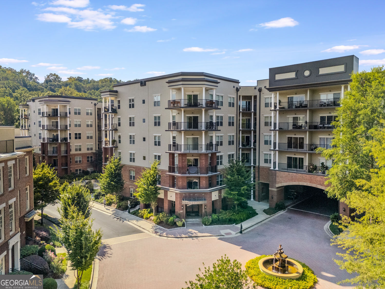 Welcome to One River Place, where luxury meets convenience! This 2-bedroom, 2-bath condo offers an updated kitchen with white cabinetry, a center island, pantry, and stainless steel appliances. The open-concept living and dining area is accented with stylish light fixtures and flows seamlessly to a covered patio. Perfect for relaxing and enjoying the serene greenery. The home features two spacious bedrooms, including a primary suite with a private bath boasting double vanities and a custom-designed closet. A freshly updated guest bath and side-by-side in-unit laundry add to the everyday ease. Two assigned parking spaces are included, along with access to an on-site electric vehicle charging station and ample guest parking. Rental rate includes water, sewer, and trash! Residents of One River Place enjoy resort-style amenities, including a 24-hour fitness center, coffee bar, private spa room, party space with catering kitchen, and a boardroom for meetings. Outdoors, unwind by the fire pit, lounge at the two saltwater pools (one heated), or gather with friends on the terrace. Scenic trails lead to the Chattahoochee River, and the community's prime location offers easy access to popular dining spots and major highways. A 24/7 staffed guardhouse ensures added security and convenience.