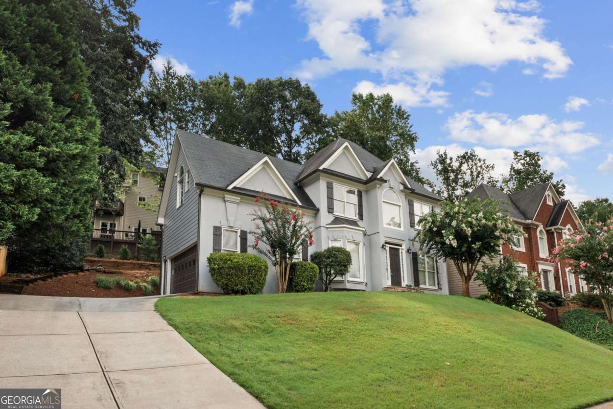 Welcome to this fabulous home in the prestigious Highland Park community! As you enter, you'll be wowed by the beautiful hardwood floors in this open plan layout. The flex room/office has the perfect view. The kitchen boasts wood cabinets, speckled granite, stainless steel appliances, working island and a Butler's pantry leading to the formal dining room. The fireside family room and breakfast room has the perfect backdrop of windows overlooking the new deck. Upstairs you will find the bedrooms and two absolutely gorgeous bathrooms! The master boasts a double shower with a seamless door and a picturesque tub, claw foot vanities, separate his/her closets and a beautiful Carrara marble that will make you feel like you're in a spa. The custom lighting and mirrors are perfection! The guest bath is the same. Gorgeous Carrara tile patterns, vanities and lighting. All this, plus you have a basement that's ready to be finished. Plumbing is already in place. Newer AC, well maintained, and ready for the next Homeowner. Walk to the award winning schools or stroll to do some shopping - or - just enjoy the beautiful amenities this community offers. Gordy Parkway is the place to be in East Cobb and you will love this house!!! This home is priced to sell for this neighborhood. What a deal!