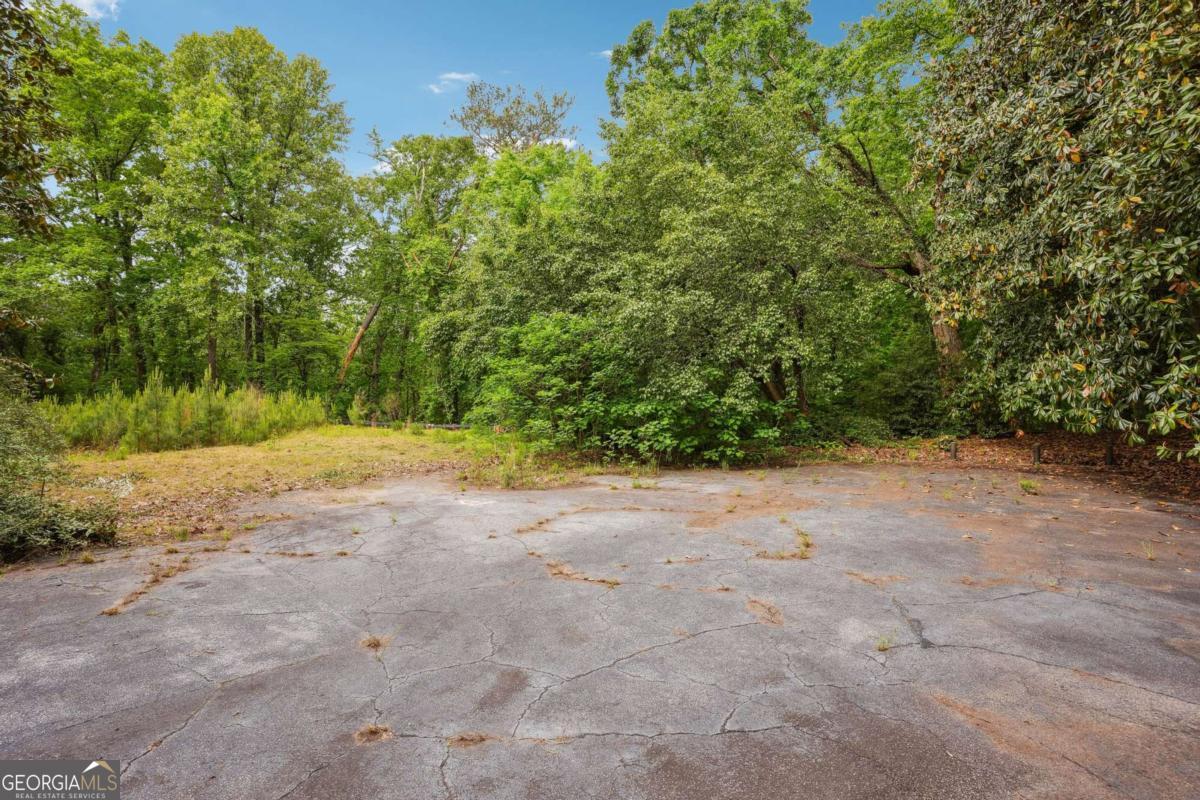 Situated in the prestigious Paces neighborhood very close to top rated school, upscale shopping, fine dining and recreational activities in Buckhead, GA. This property offers a rare opportunity to build your dream home on a sprawling 4.46 acre lot. Surrounded by estate properties and beautifully wooded large lots, the property provides a private setting for a residence with over 400 feet wide. The lot is ready for construction, with house plans designed by renowned architect Rodolfo Castro and building permits approved. These plans are tailored to complement the long drive to the build site at the hilltop with magnificent views of treetops and serene environment. This exceptional property with tranquil surroundings presents a great opportunity to create a peaceful retreat in the heart of Buckhead.