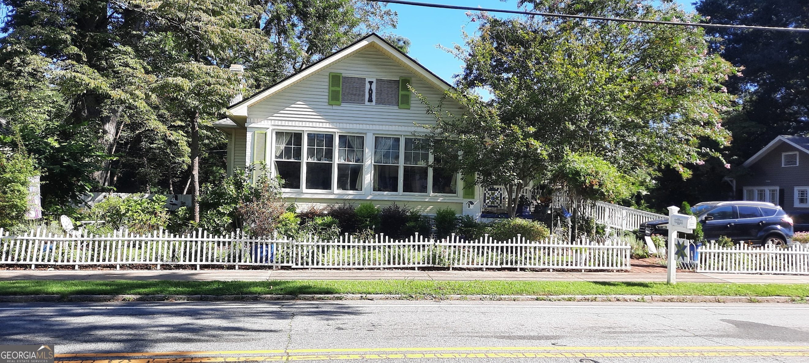 Presenting an exceptional opportunity to acquire a distinguished historic garden residence in the heart of Carrollton. This botanical haven is nestled within a well-established neighborhood renowned for its serene ambiance and sense of community. The property is ideally positioned to offer convenient access to the acclaimed Carrollton GreenBelt, a sprawling network of trails perfect for walking, cycling, and outdoor recreation. Residents will enjoy proximity to the city's vibrant cultural landscape, including esteemed institutions such as the Southeastern Quilt and Textile Museum and the Carrollton Center for the Arts. Carrollton is celebrated for its rich historical heritage, a diverse selection of dining experiences, and a thriving live music scene that contributes to its dynamic community spirit. This location seamlessly blends tranquility with culture, making it a truly desirable place to call home.