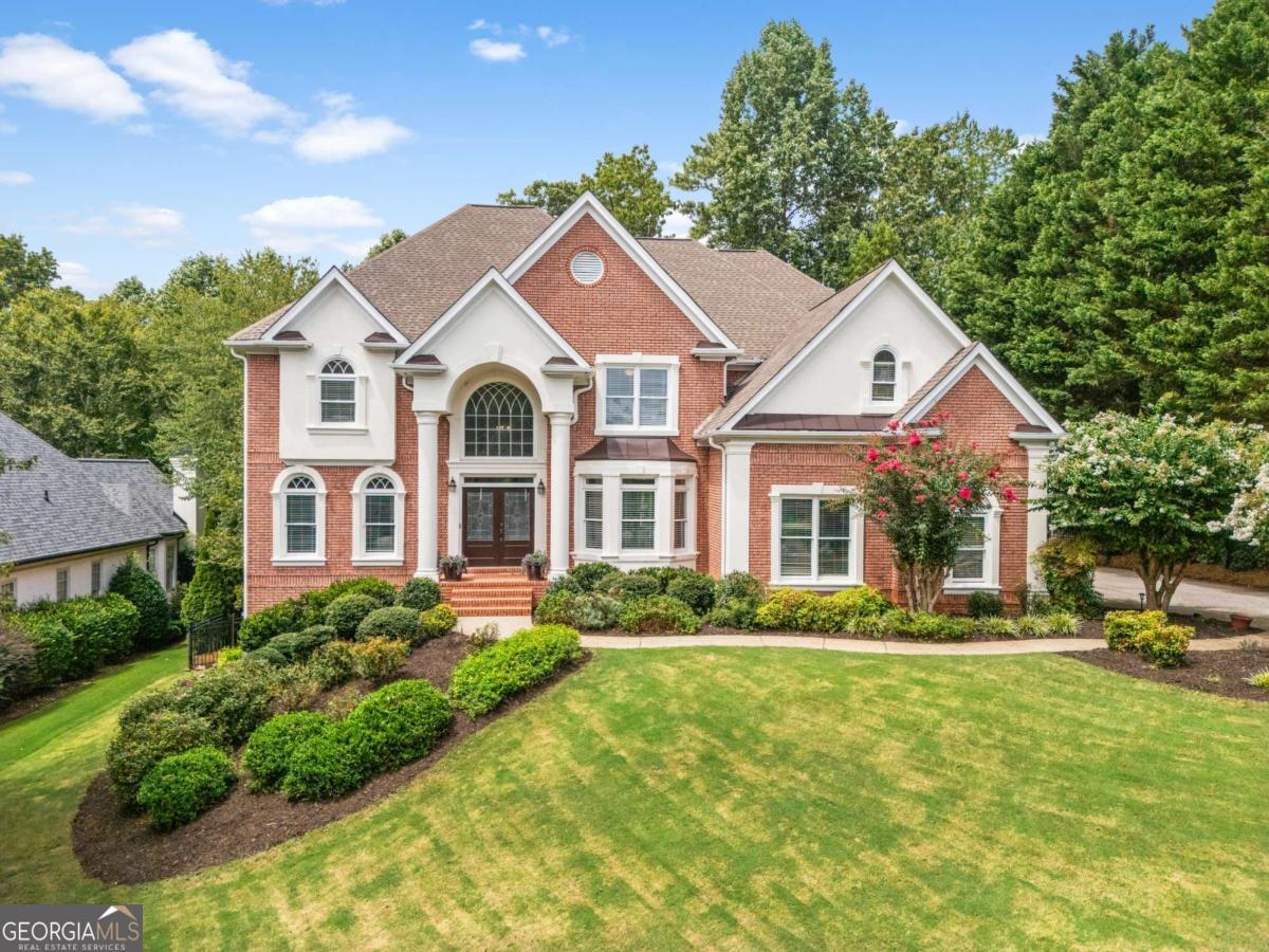 Your Milton dream home awaits on the 15th green! This stunning Crooked Creek property features a private pool and hot tub - the perfect backyard paradise with breathtaking views. Enjoy resort-style living, golf-course luxury, and an incredible neighborhood full of amenities and social activities. Tucked onto a quiet street, this home greets you with impressive curb appeal and a grand two-story entry foyer. Off the entryway, you'll find a formal dining area, as well as a versatile office - perfect for work-from-home life. The heart of the home is the entertainer-ready chef's kitchen, complete with a large island and eat-in area that opens into the family room. Step out onto the deck and the backyard truly comes alive-the pool and golf course set the scene for your favorite summer parties (or quiet mornings with coffee and a sunset view). Also on the main floor is a guest suite with a full bath, perfect for visiting guests or additional flex space. Upstairs, the oversized primary suite feels like its own sanctuary, with a sitting area, luxe bath with dual vanities, separate tub and shower, and more golf course views. Three additional bedrooms and bonus room offer flexibility for family, guests, or a bonus home office. The unfinished basement gives you room to grow, whether you envision a gym, game room, or workshop. Additional features include a three-car garage, fresh paint, new floors, updated design fixtures, flat driveway and professional landscaping. With its flat, private yard, incredible golf course setting, and resort-style neighborhood amenities, this home is a gem. This amazing location is just minutes from downtown Alpharetta, Crabapple, Halcyon, Avalon, with convenient access to GA 400. Don't miss this great opportunity!