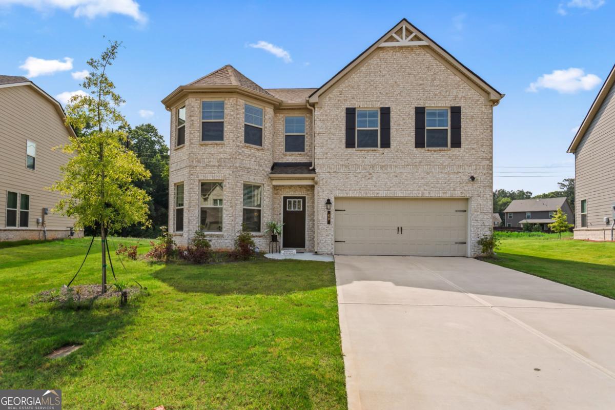 Welcome to this better-than-new 5 bedroom, 3 bathroom home tucked just behind Bay Creek Park and zoned for the highly sought-after Grayson Schools! Built in 2023, this thoughtfully designed home features a full guest suite on the main level-perfect for visitors or multi-generational living.The main floor offers a formal dining room, cozy living room with a fireplace, a separate family room, and an eat-in kitchen with a sunny breakfast nook. The open-concept kitchen is a showstopper with quartz countertops, upgraded lighting, and luxury vinyl plank flooring that flows seamlessly throughout the home.Upstairs, you'll find four spacious bedrooms, including a luxurious oversized primary suite with a generous sitting area-your own private retreat. Bathrooms feature beautiful modern tilework and elevated finishes throughout.Enjoy a flat, private backyard that's ideal for relaxing, playing, or entertaining guests. Just steps away, Bay Creek Park offers tennis courts, basketball courts, walking trails, and a playground. Plus, you're only minutes from shopping and dining at The Shoppes at Webb Gin.