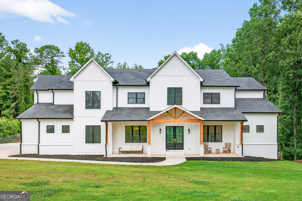 LOCATION, LOCATION, LOCATION!! This custom-built master-on-main home is located in the HIGHLY SOUGHT AFTER BUFORD CITY SCHOOL DISTRICT, with the added bonus of lower Hall County taxes! Nestled on a private 1.15-acre lot and set back from the road with a 350-foot paved driveway, this one-of-a-kind property offers both seclusion and convenience-just a few minutes from Lake Lanier, schools, shopping, restaurants, downtown Buford, and I-985. As you step inside the main level, you're greeted by soaring 10-foot ceilings that create a bright and open atmosphere. A formal dining room sets the tone for elegant entertaining, while the heart of the home-a massive designer kitchen-boasts stunning quartz countertops, an oversized 11-foot island, an 8-burner gas range, and a walk-in pantry featuring custom cabinetry. Just off the kitchen, you'll find a convenient mudroom and half bath. The living room is truly a showstopper with its 22-foot vaulted ceilings, a dramatic floor-to-ceiling fireplace, and custom built-in shelving. The owner's suite, located on the main level, is a private retreat complete with direct access to a spacious 722-square-foot covered deck. The en-suite offers a spa-like experience with an oversized soaking tub, a massive walk-in shower equipped with dual shower heads and built-in Bluetooth speaker, and a large double vanity. Also on the main level is a beautifully crafted home office with custom built-in cabinetry, ideal for those working remotely. The laundry room is thoughtfully placed on the main floor and includes a convenient laundry chute from the upper level. Upstairs, you'll find four generously sized bedrooms, each with access to two Jack-and-Jill bathrooms that feature floor-to-ceiling tiled showers. A large bonus room offers endless possibilities-from a playroom to a home theater or guest suite. The unfinished daylight basement adds an additional 2,083 square feet and is already stubbed for a full bath and wet bar or second kitchen, allowing you to expand the living space to suit your needs. Outdoor living is just as impressive, with a 722-square-foot covered back deck overlooking a sprawling, flat backyard that's perfect for entertaining or adding a pool. The home also features a tankless water heater, and a 930-square-foot three-car tandem garage with brand-new epoxy flooring. This is truly a rare opportunity to own a one-of-a-kind home in the nationally top-rated Buford City School District. Thoughtfully designed, impeccably built, and ideally located-this home checks every box. Come see it before it's gone!