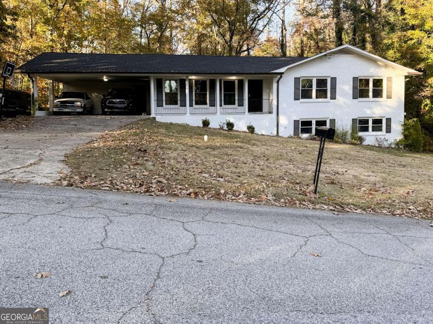 Welcome to this beautifully updated 3 bedroom, 2 bath, four-sided brick home situated on a serene 1.2-acre lot. The home underwent a thorough 2023 renovation including a new roof, new HVAC, new flooring, new kitchen cabinets, granite countertops, updated bathroom showers and vanities, modern fixtures, and a new water heater. The spacious back deck offers plenty of room for outdoor dining and entertaining, all while enjoying the peaceful wooded views.The full daylight basement is already studded and ready for your vision, offering endless potential for expansion and added value! Enjoy being just minutes away from all the dining, shopping, and entertainment in downtown Douglasville. Don't miss out! Schedule a showing today!