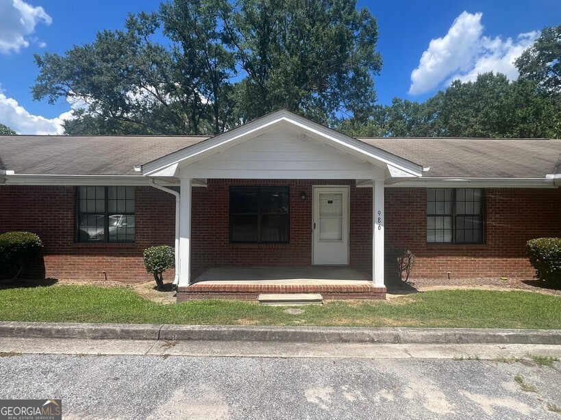 2 Bedroom, 2 Bath in the heart of Olde Town Conyers featuring a large family room, eat-in kitchen with stove, dishwashwer & refrigerator, spacious front bedroom with private bath, large back bedroom, hall bath, laundry / storage room, rocking chair front porch, deck & 2 dedicated parking spots.